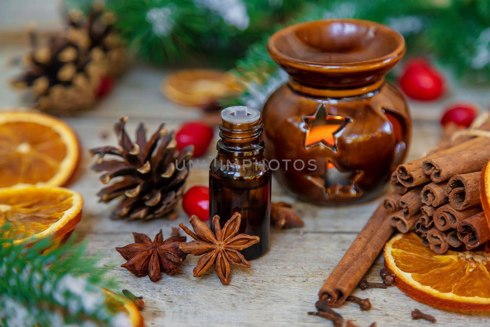 Christmas essential oils in small bottles. Selective focus. Nature.