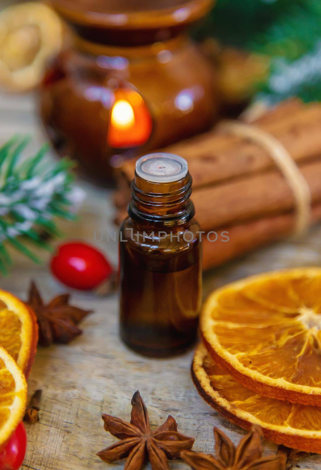 Christmas essential oils in small bottles. Selective focus. Nature.