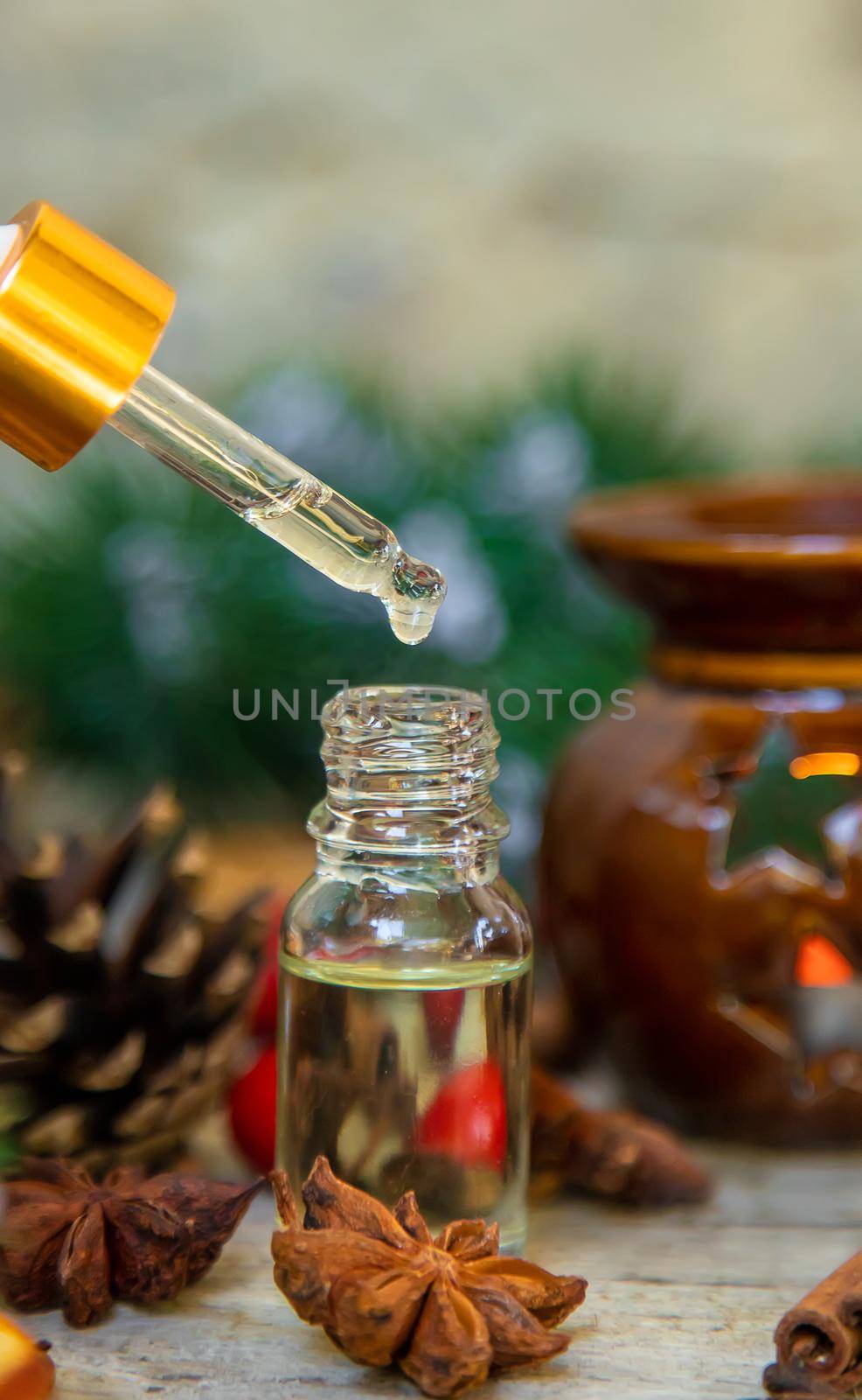 Christmas essential oils in small bottles. Selective focus. Nature.