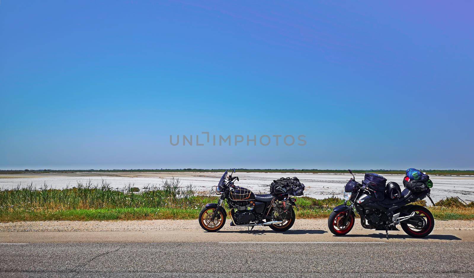 motorcycles parked on the side of the road during a trip to Camargue near Lake Sale