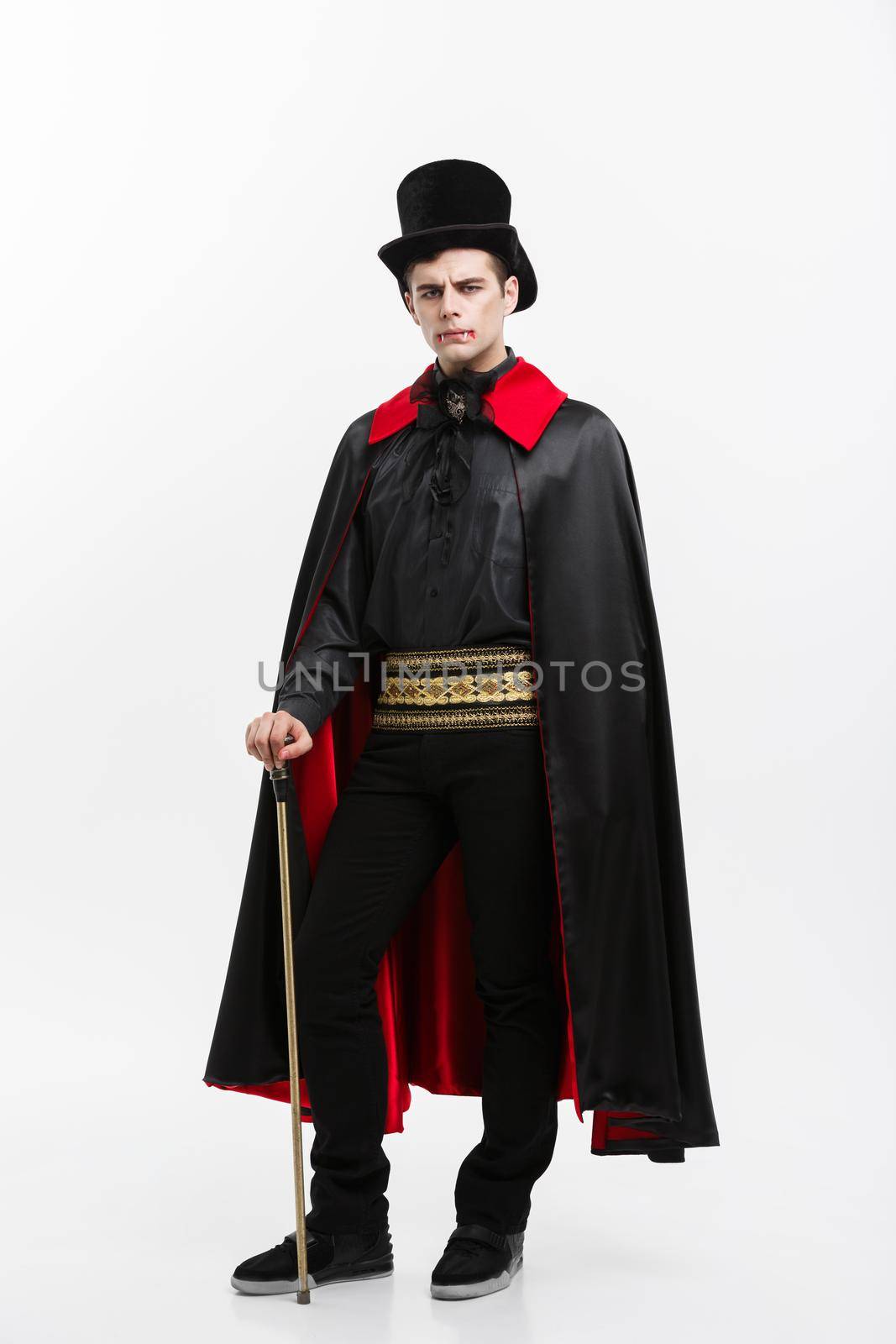 Vampire Halloween Concept - Full lenght Portrait of handsome caucasian Vampire in black and red halloween costume. by Benzoix