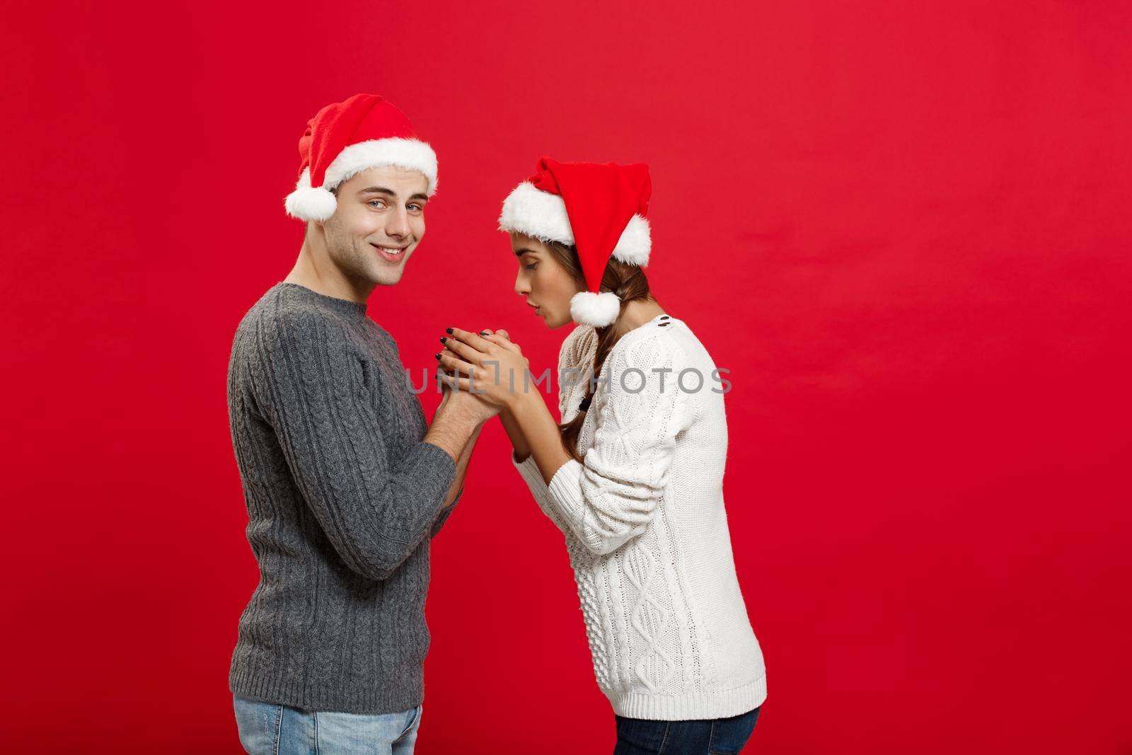 Christmas Concept - young stylish couple holding hand each other in winter.