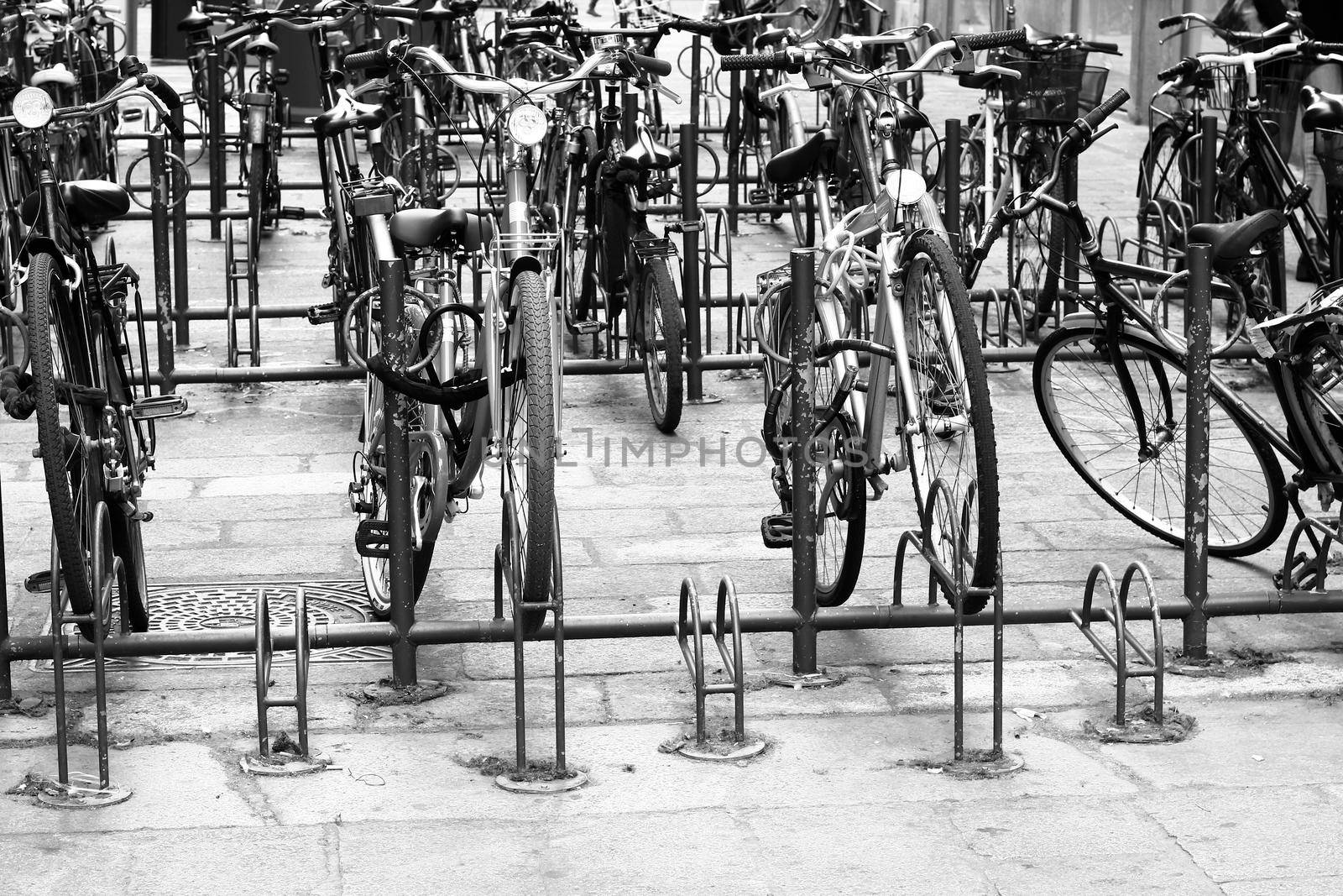 Old vintage bikes parked on the edge of the road.