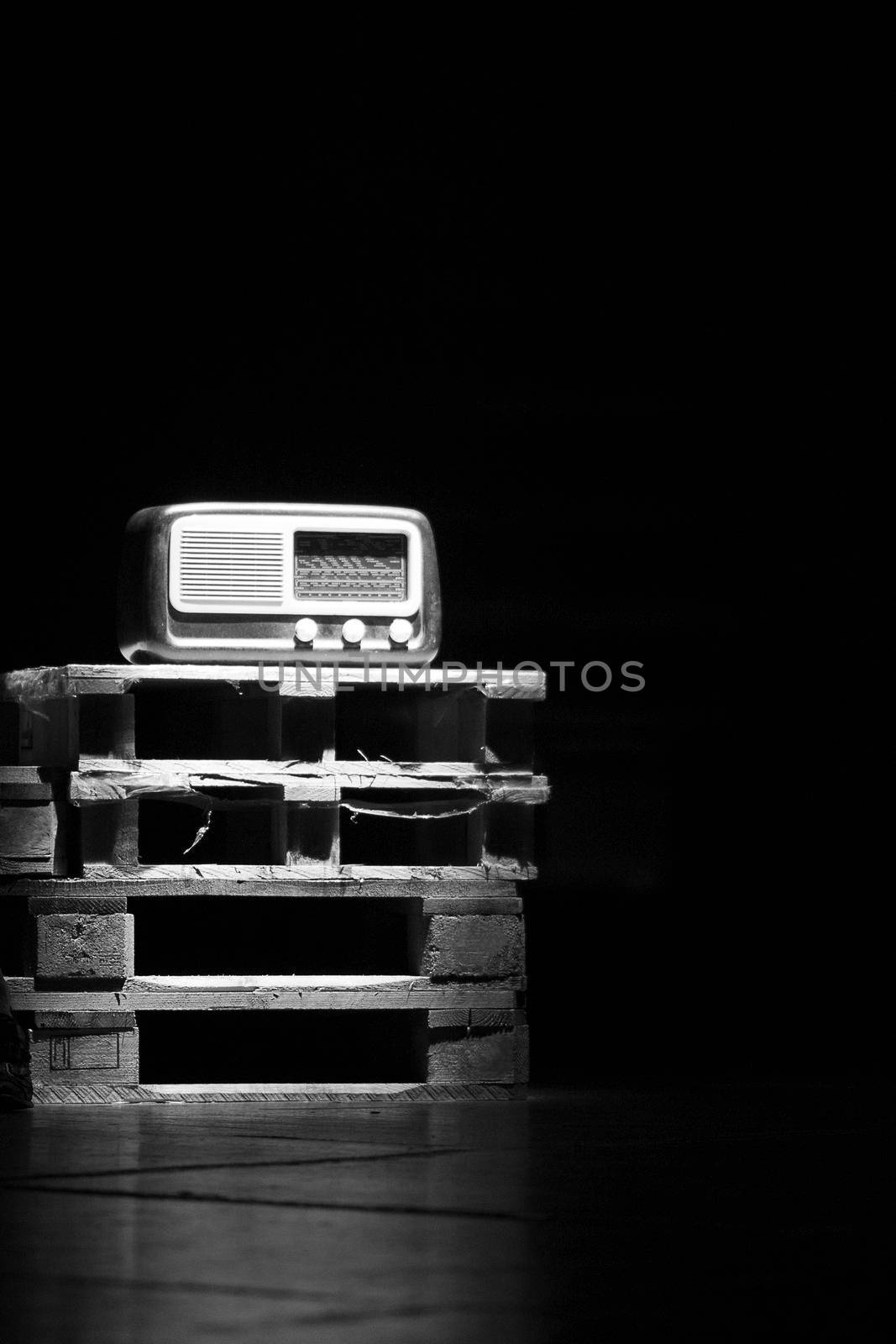 An old radio vintage over wooden pallets.