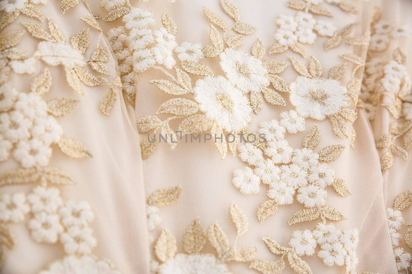 detail of a wedding dress with embroidered flowers