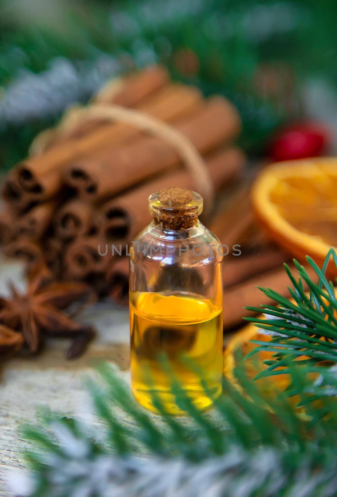 Christmas essential oils in small bottles. Selective focus. Nature.