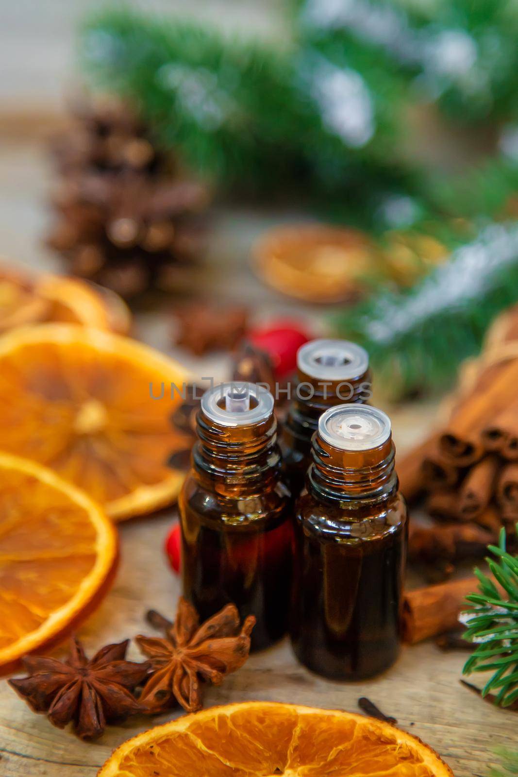 Christmas essential oils in small bottles. Selective focus. Nature.