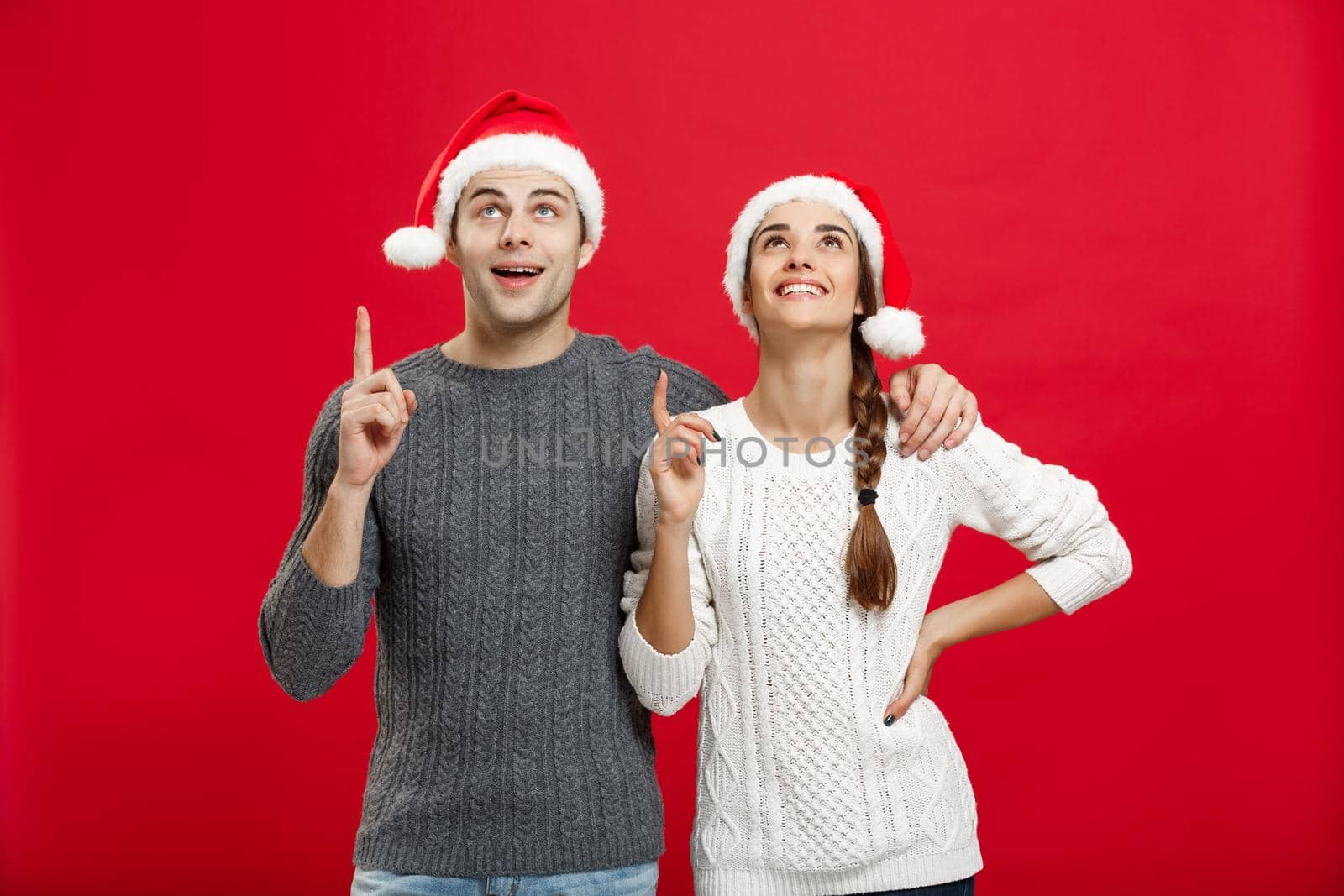 Christmas Concept - portrait lovely young couple finger on side well use for presentation or montage.