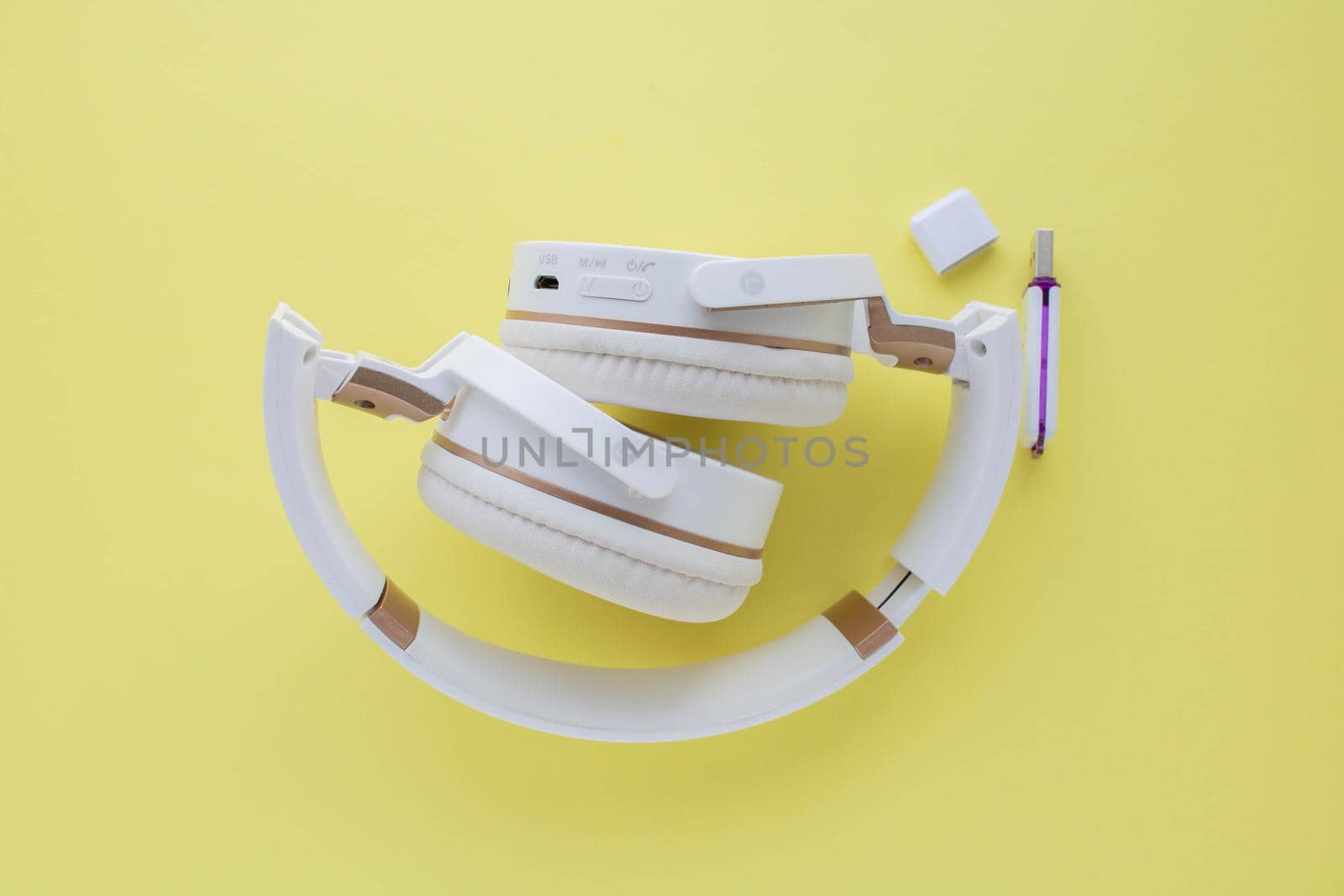 Wireless headphones isolated on a yellow background