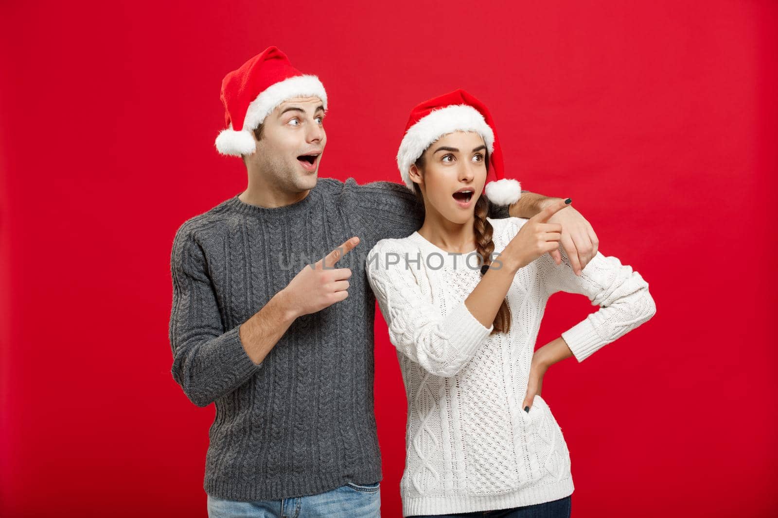 Christmas Concept - portrait lovely young couple finger on side well use for presentation or montage.