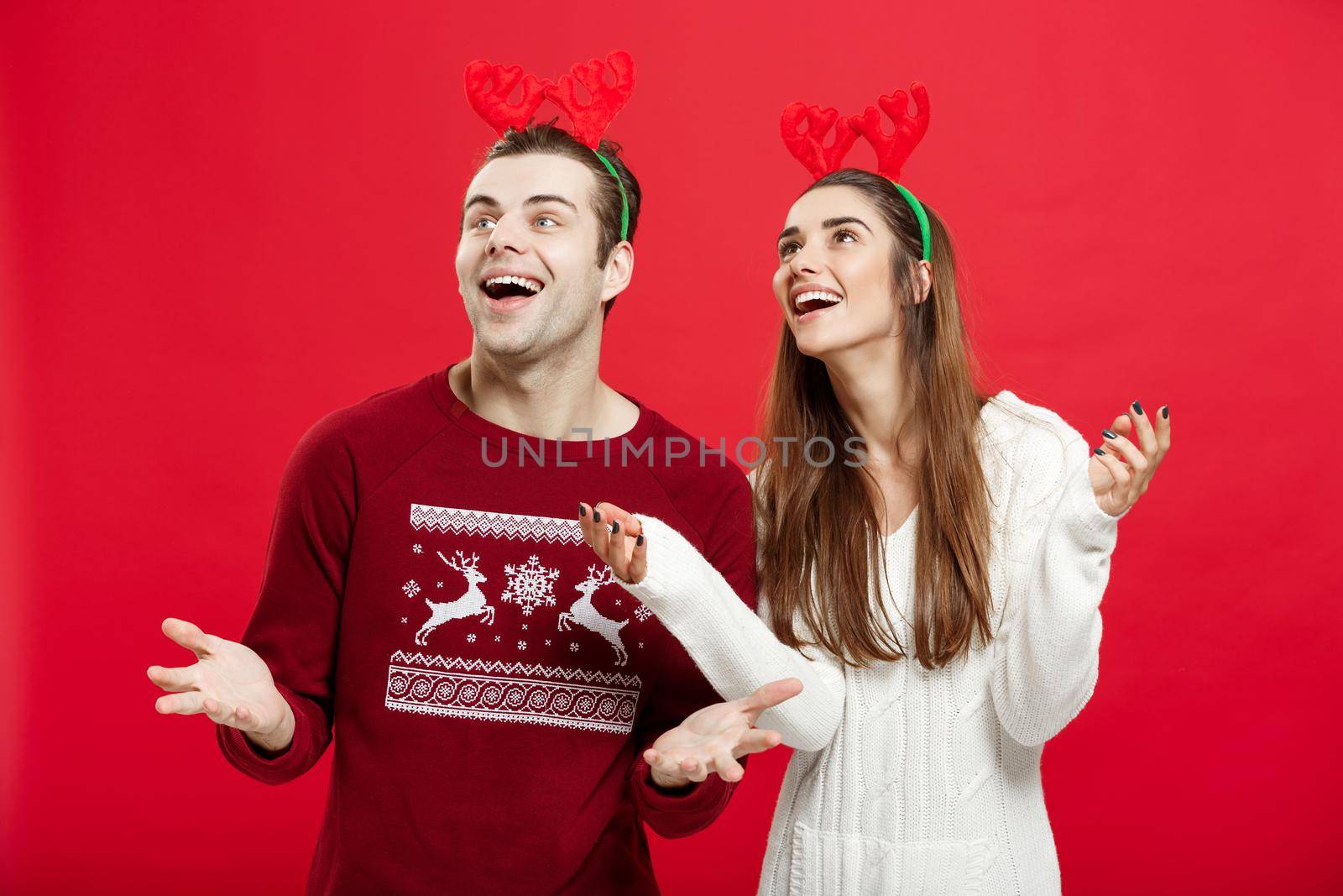 Christmas Concept - Romantic couple in a christmas sweaters waiting for snow by Benzoix