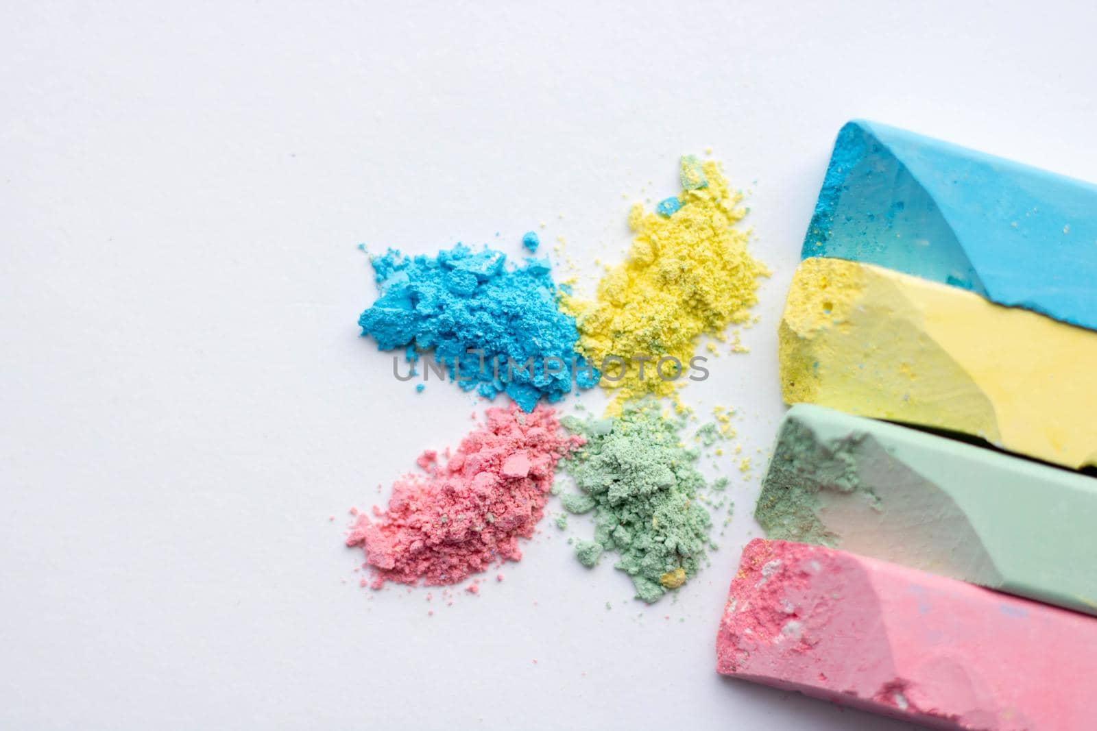 Square colorful pastel chalks tops closeup, on white background. by lapushka62