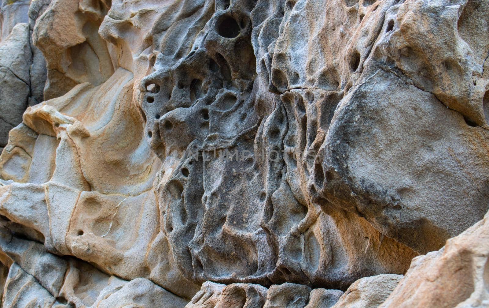 Texture, background layers and cracks in sedimentary rock on cliff face. Cliff of rock mountain. Rock slate in the mountain. Seamless abstract background. Cracks and layers of sandstone by lapushka62