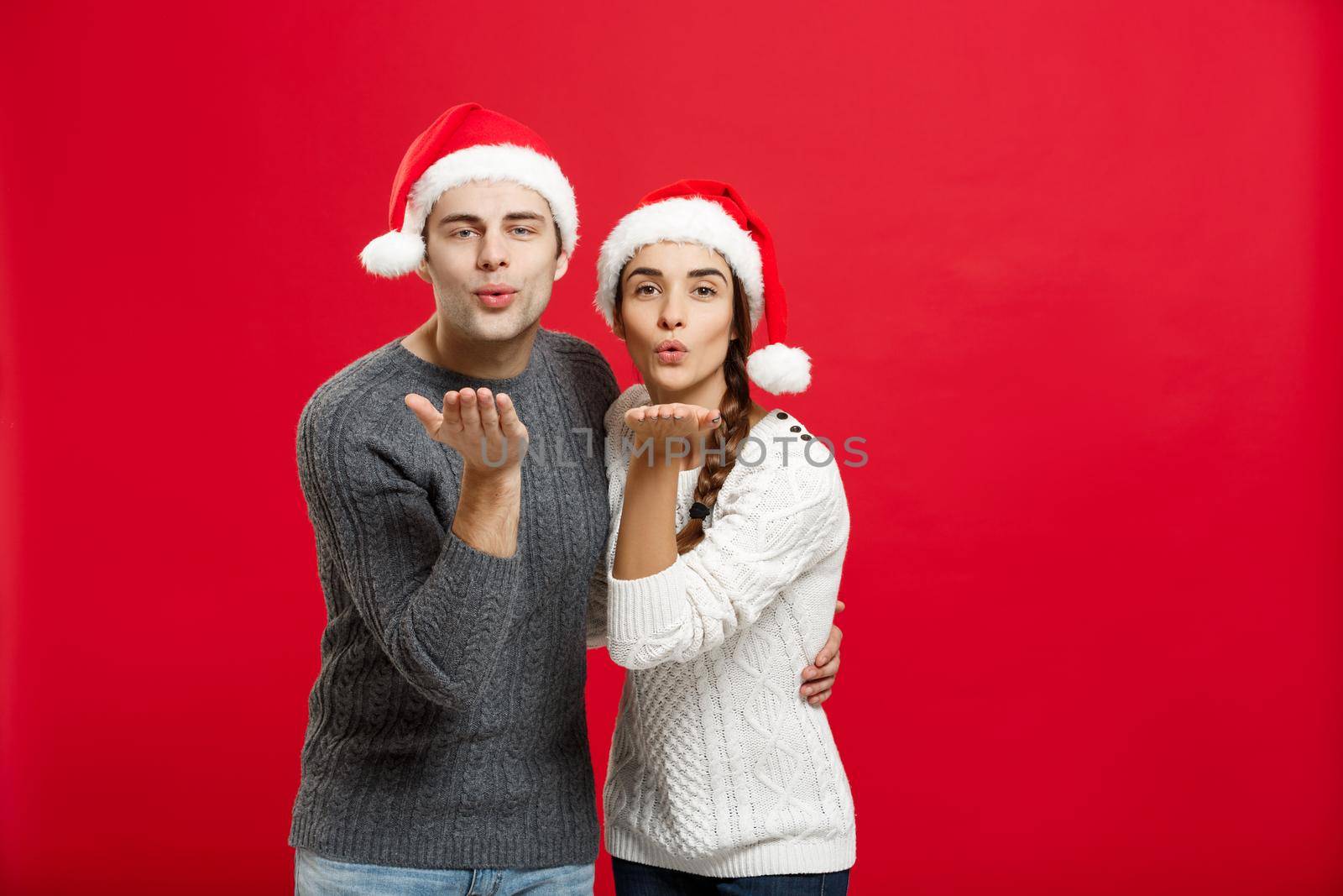 Christmas Concept - portrait lovely couple blowing wish to camera in Christmas day by Benzoix