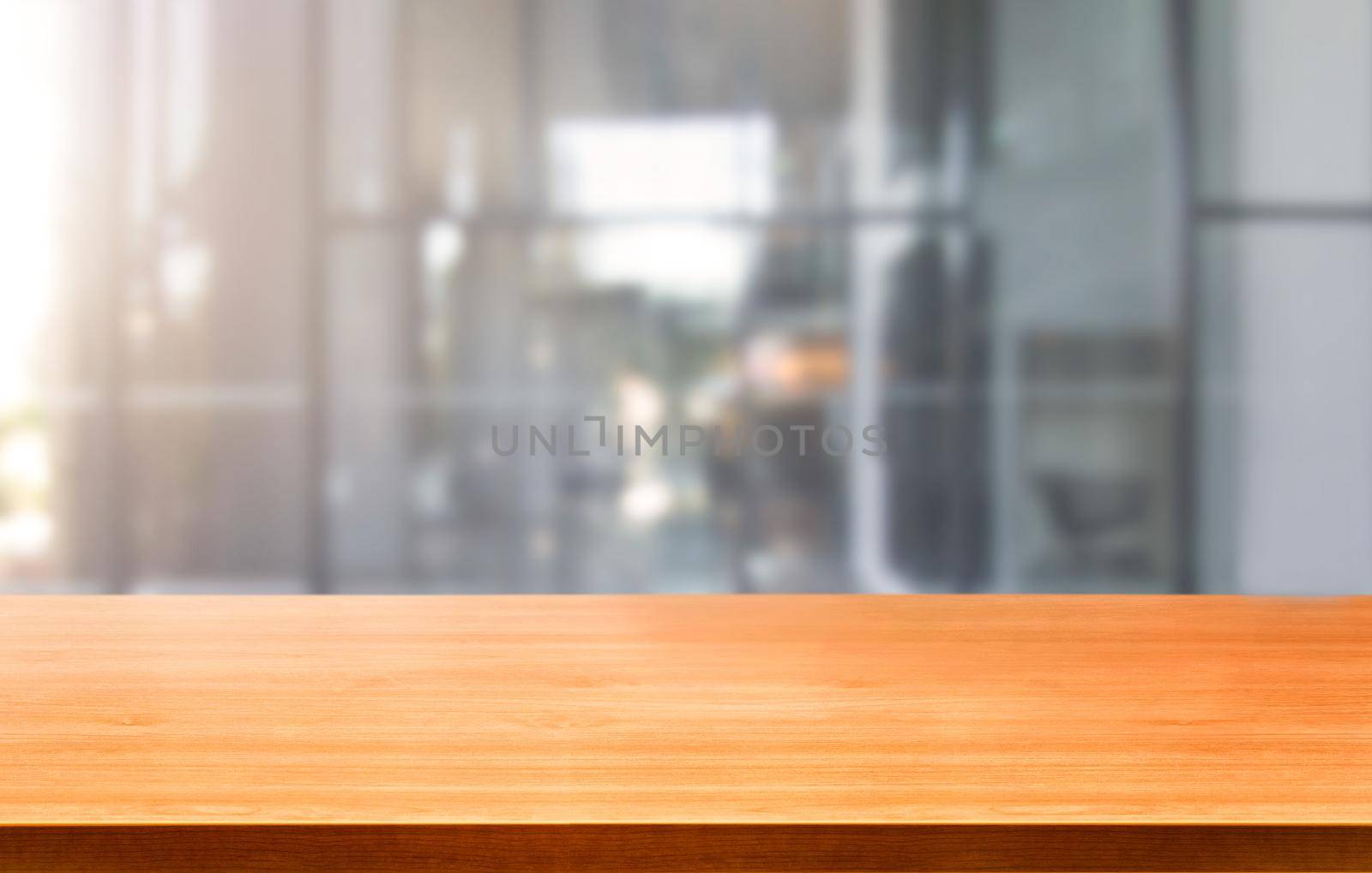 Wood table in city center modern office background with empty copy space on the table for product display mockup. Workspace desk interior and place for corporate business.