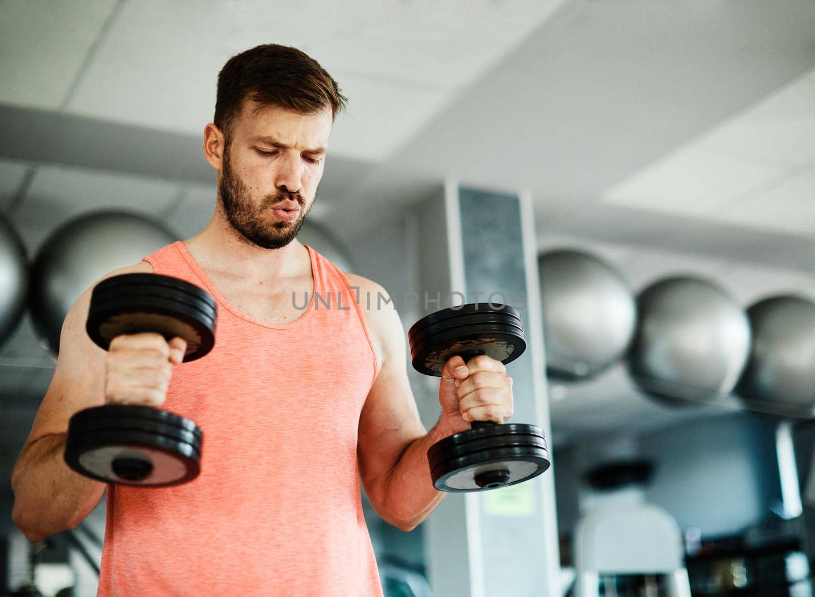 Portrait of healthy fitman at the gym exercising