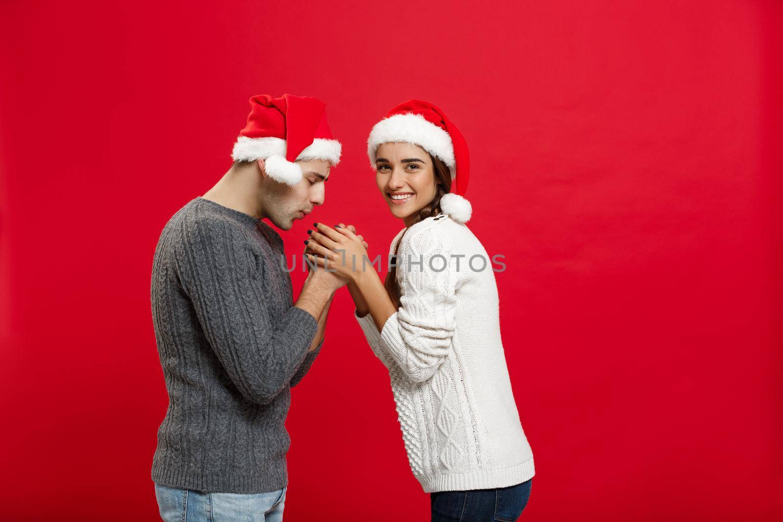 Christmas Concept - young stylish couple holding hand each other in winter.