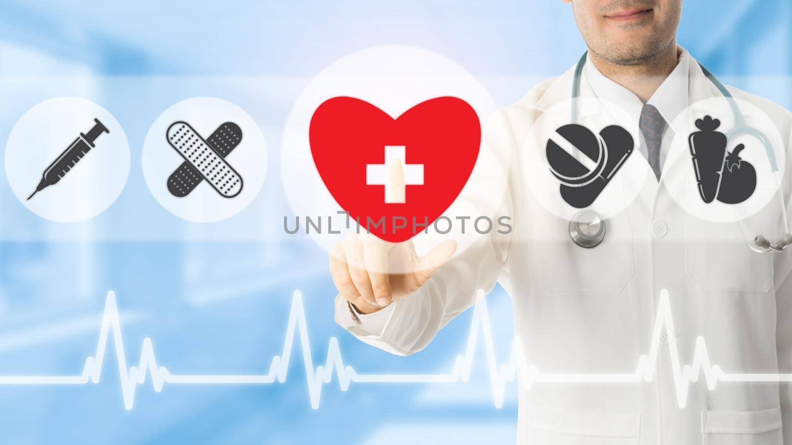 Doctor pointing at heart symbol icon on blue hospital background. Medical and healthcare concept.