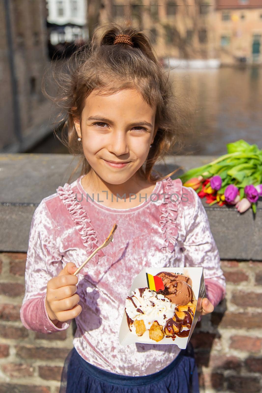 Belgian waffles are eaten by children on the street. Selective focus. Food.