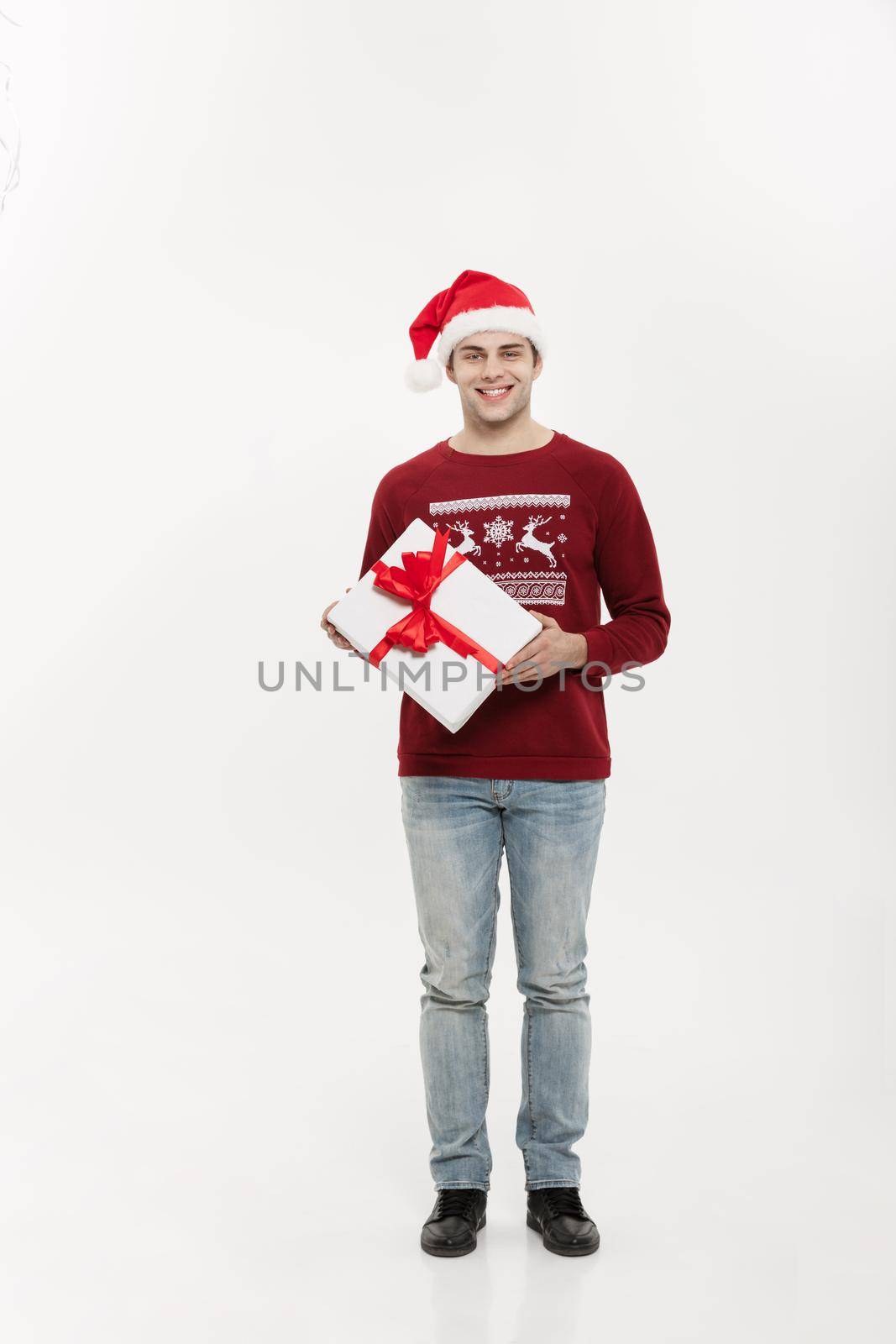 Christmas Concept - Full-length handsome young man in sweater wi by Benzoix