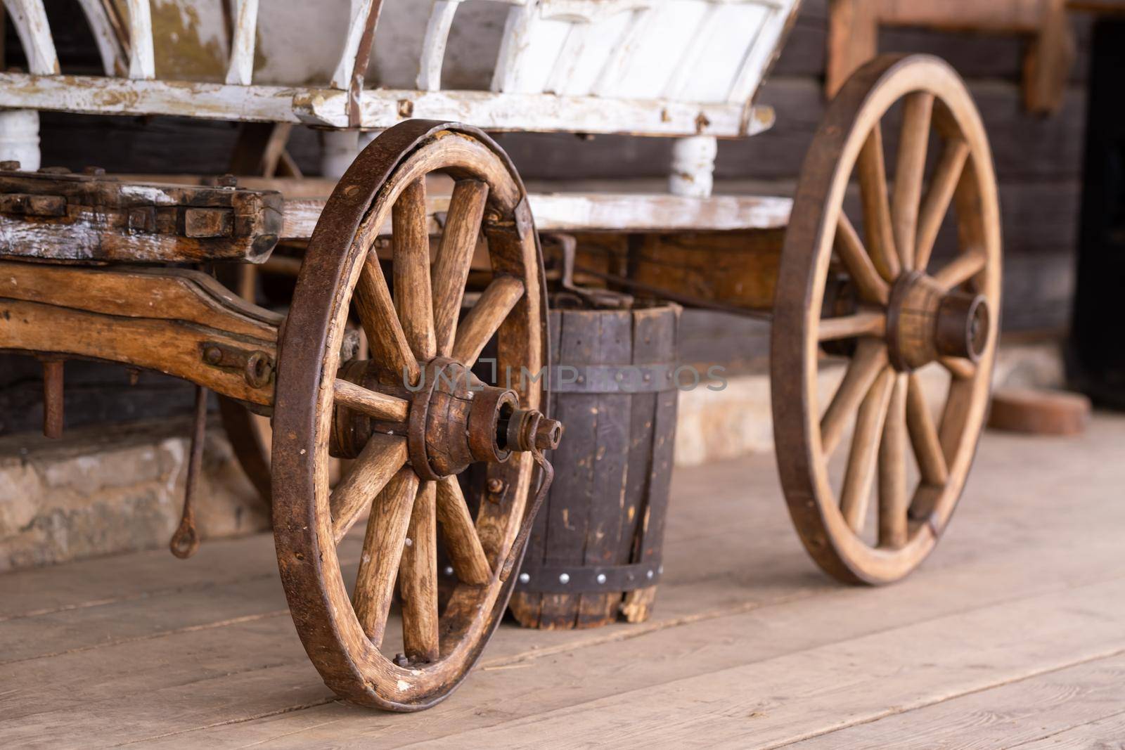 old wooden wheels are on the carriage at the ranch by Lobachad