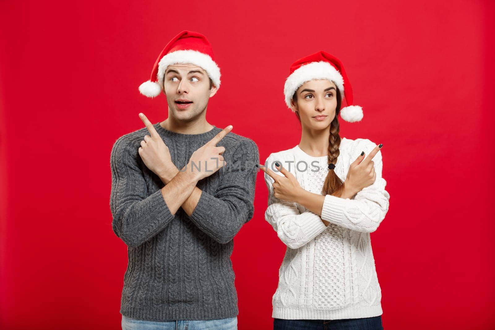 Christmas Concept - portrait lovely young couple finger on side well use for presentation or montage.