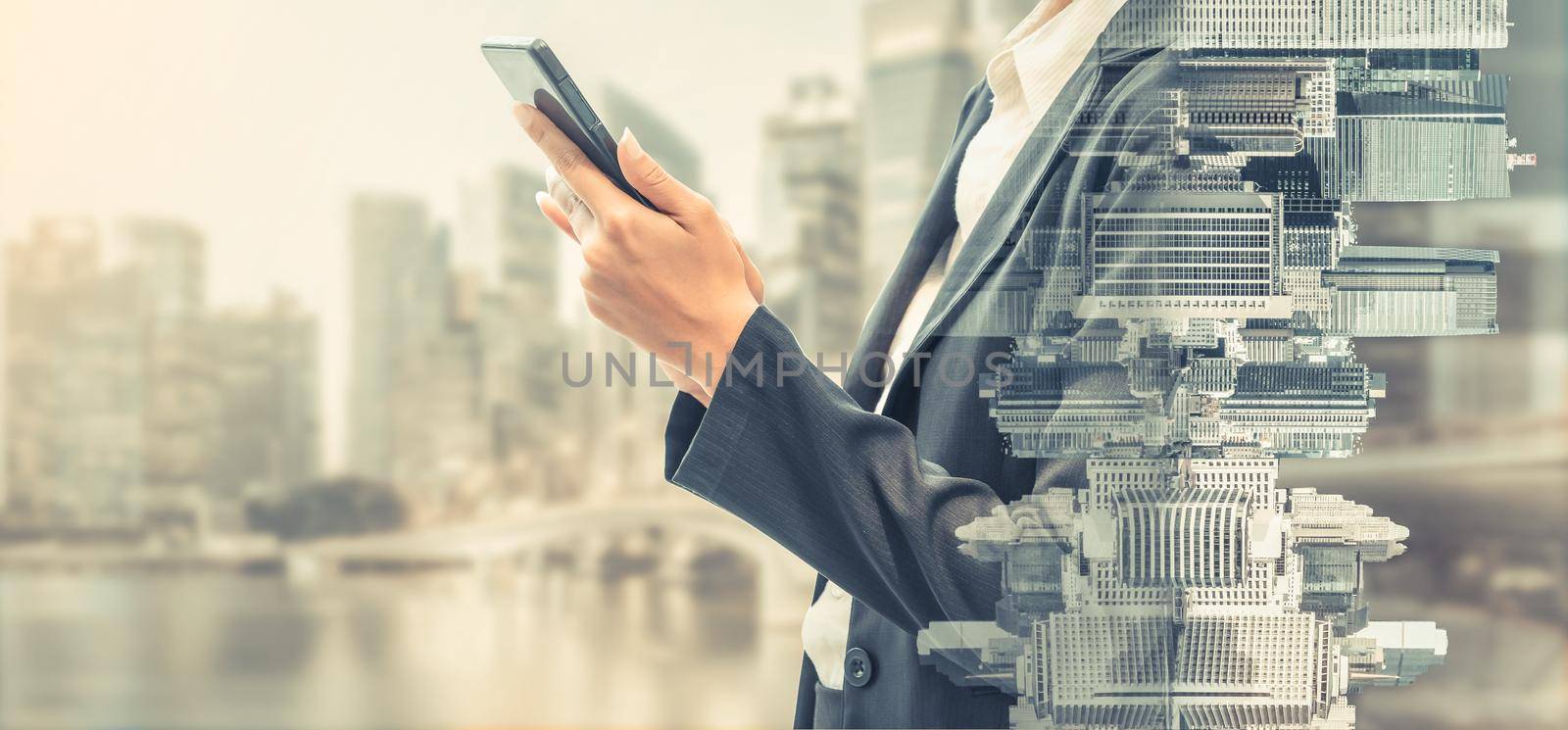 Young businesswoman using mobile phone with modern city buildings background. Future telecommunication technology and internet of things ( IOT ) concept.