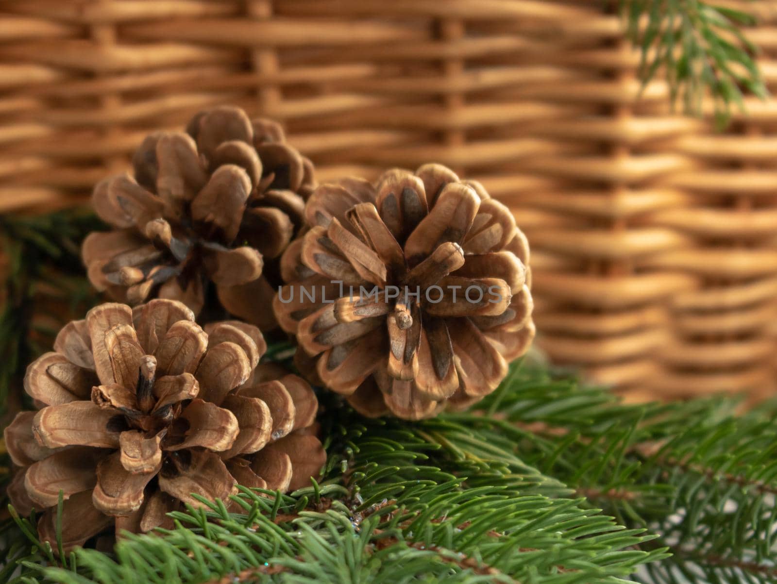 pine cones in a wicker basket on a brown background.chrismas holidays.