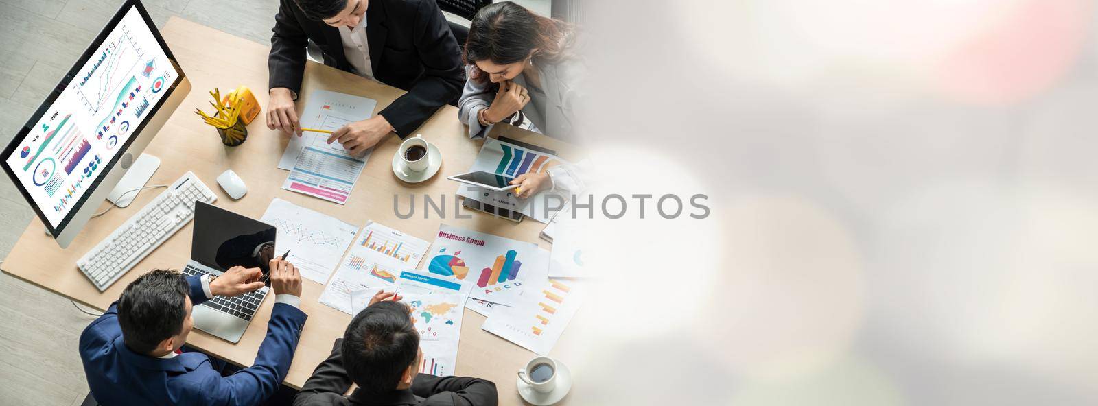 Business people group meeting shot from top widen view in office . Profession businesswomen, businessmen and office workers working in team conference with project planning document on meeting table .