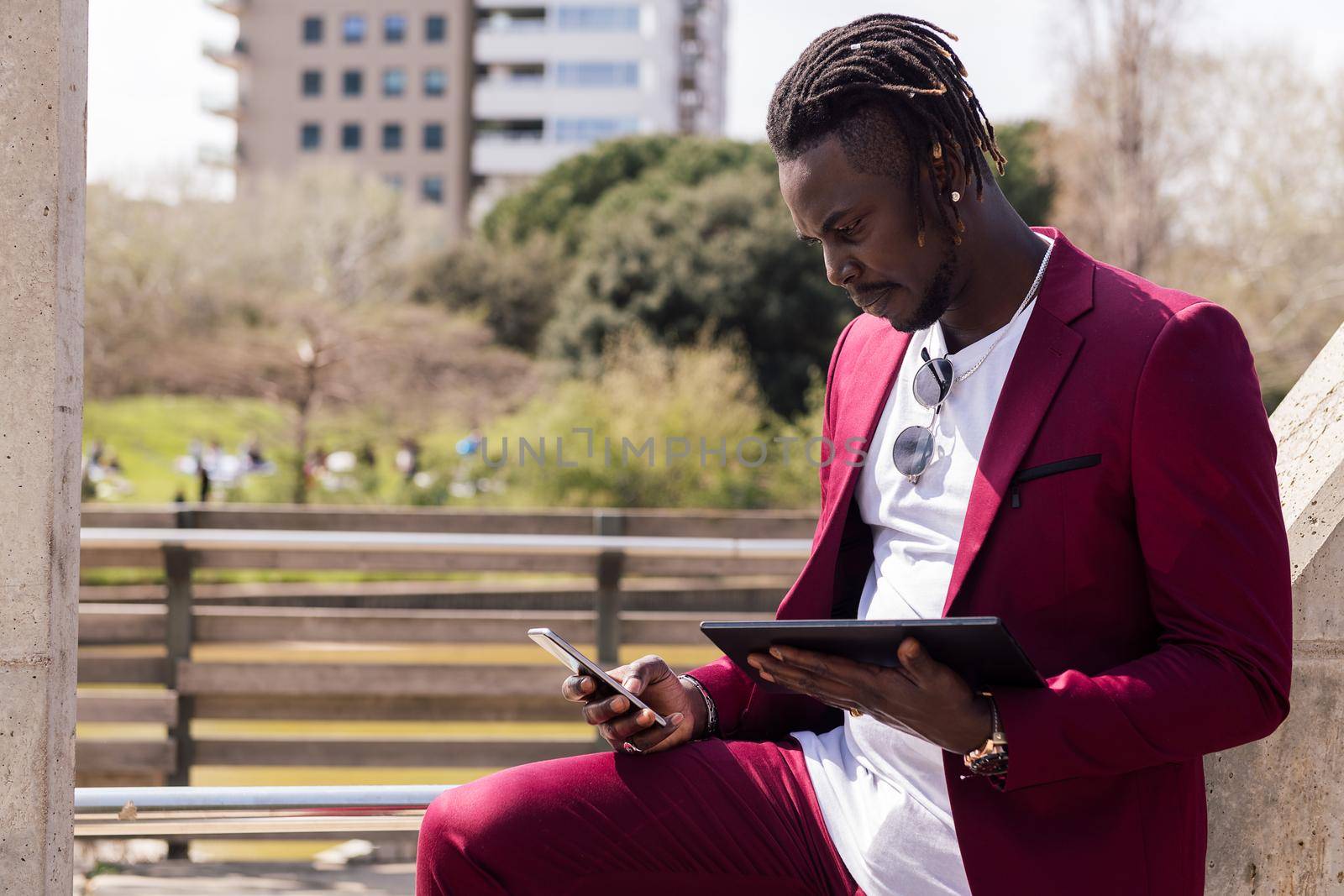 black businessman using a tablet and smart phone by raulmelldo