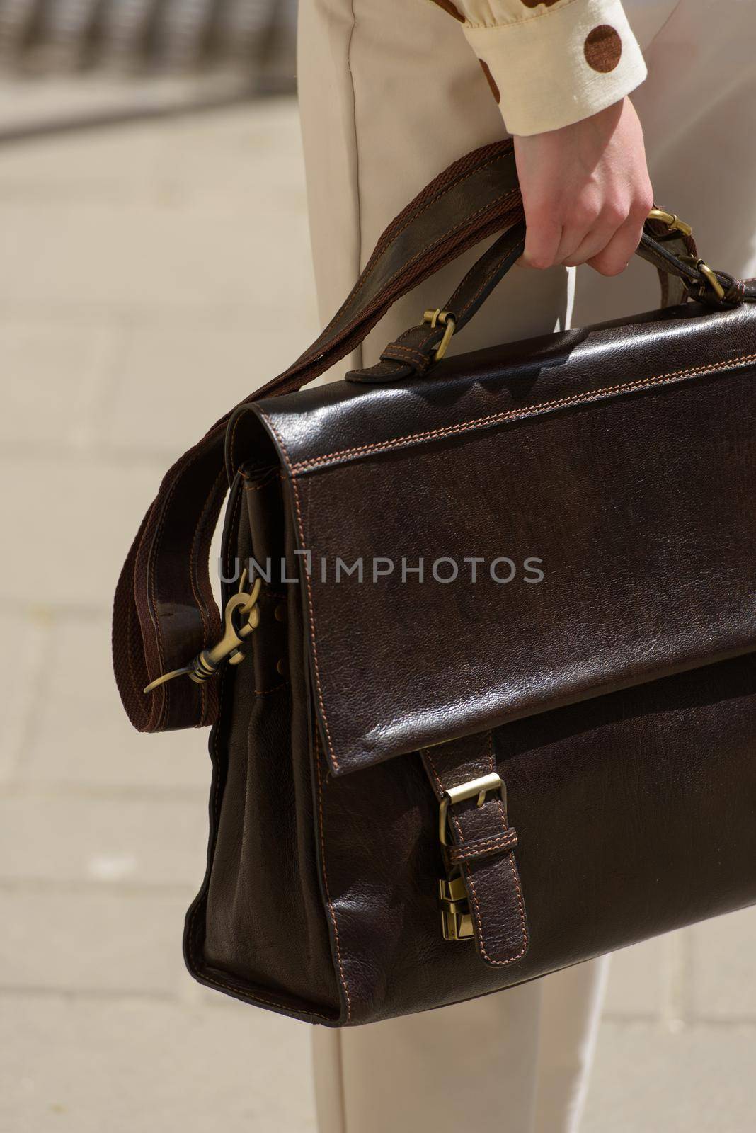 Part photo of a woman with a brown leather briefcase with antique and retro look. Outdoors photo by Ashtray25