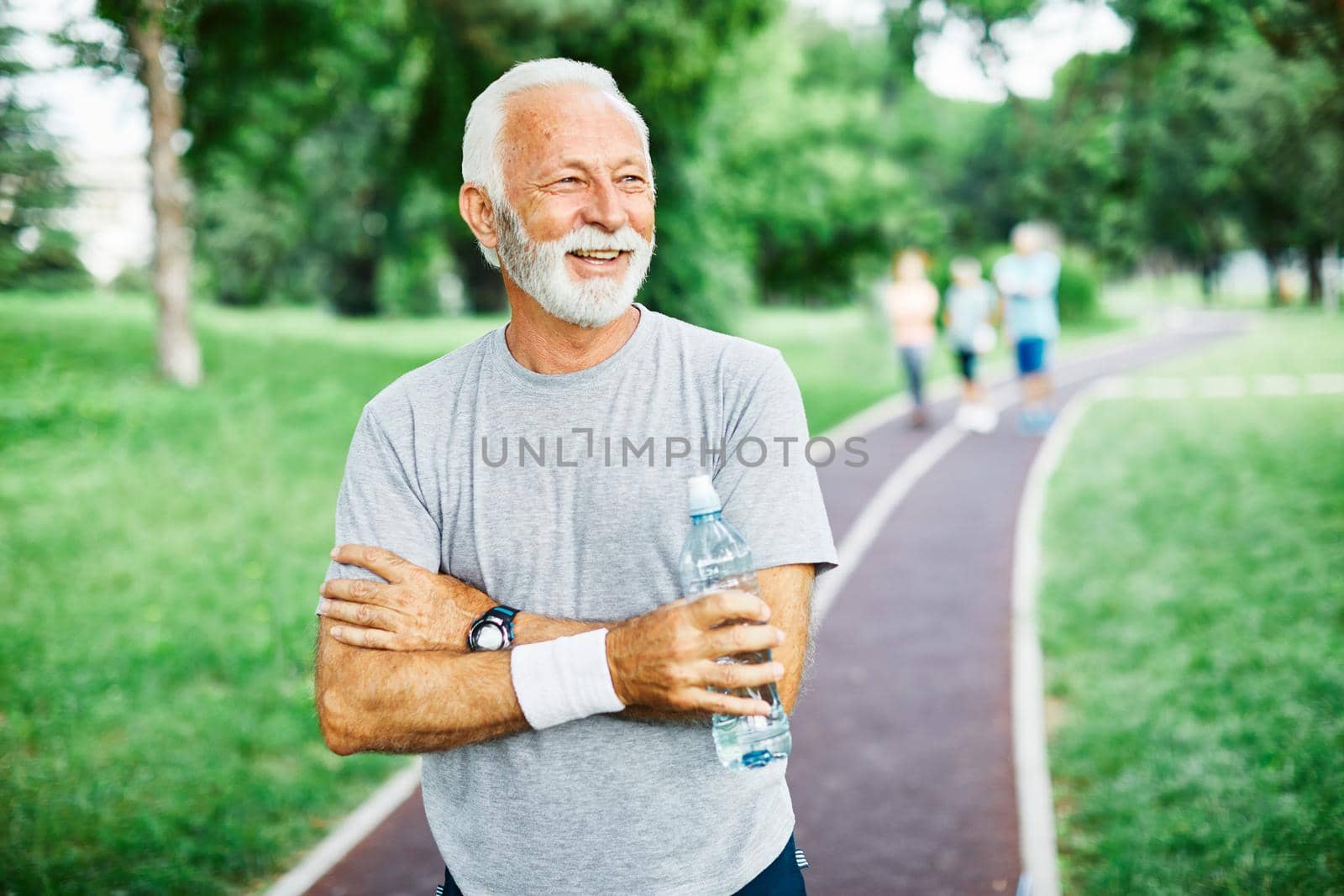 Portrait of a happy active senior man posing after exercicing outdoors