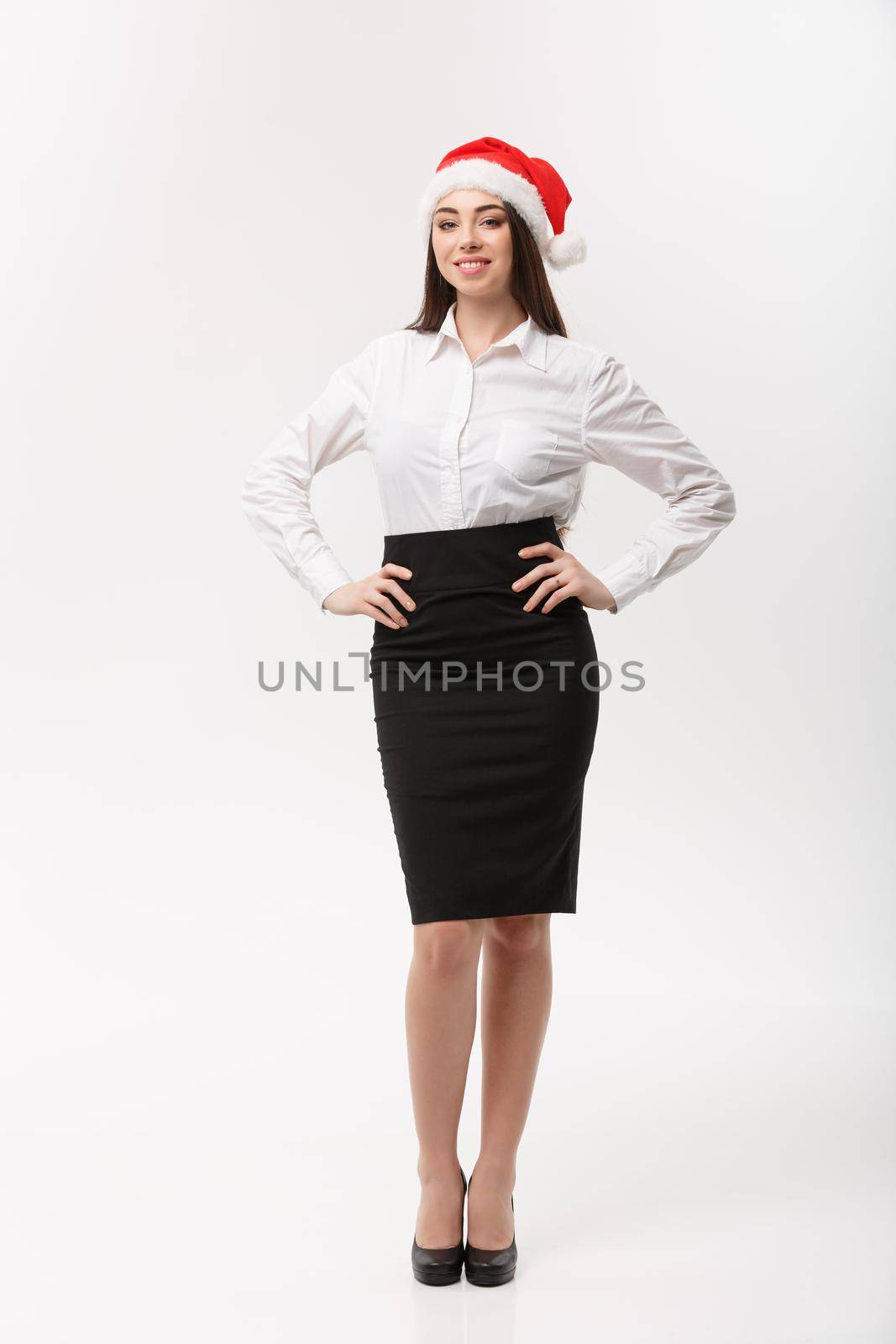 Business Concept - Modern caucasian business woman in christmas theme posing on white studio background with copy space.