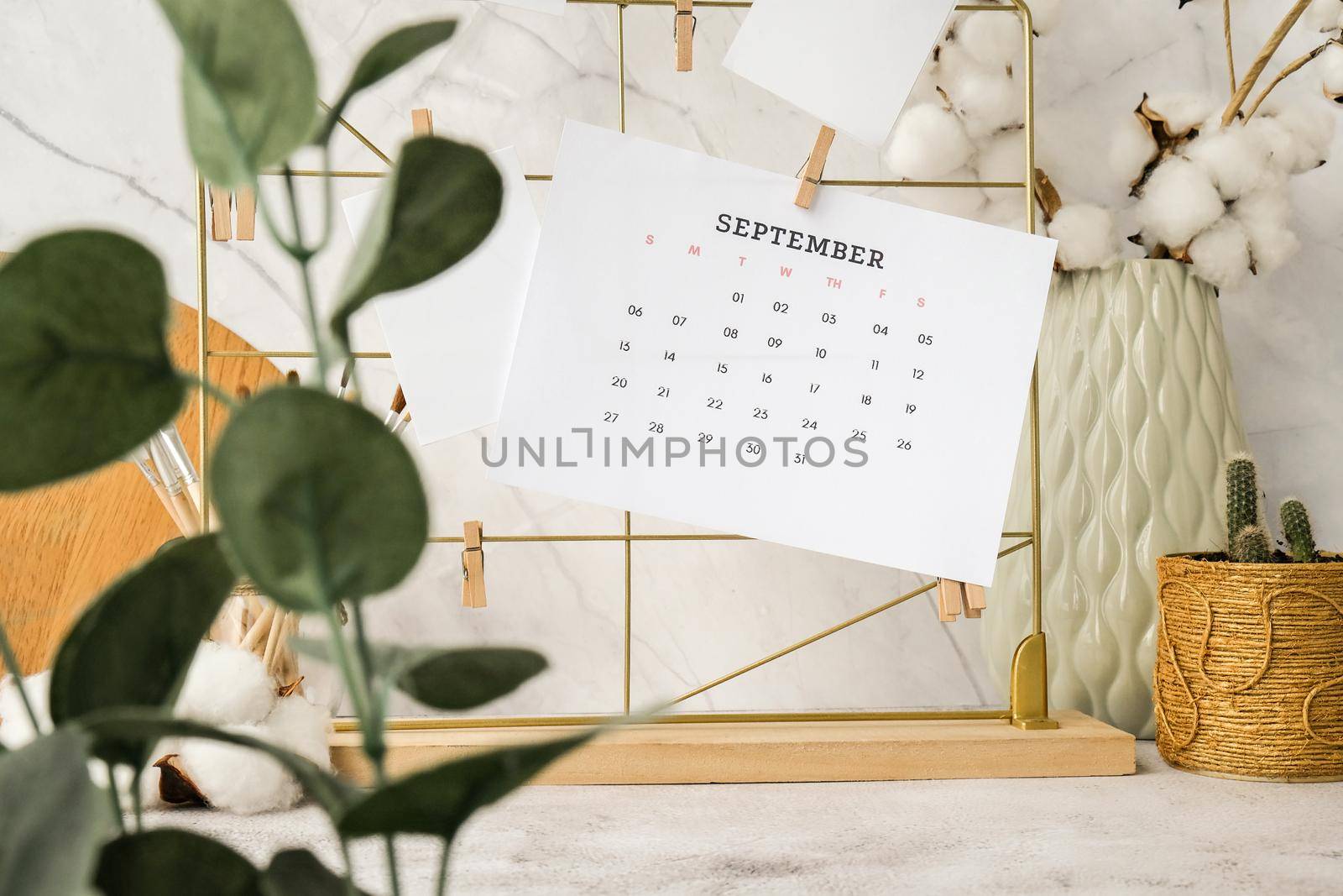 SEPTEMBER CALENDAR Cards and posters mock ups on grid board. Copy space. Home office desktop. Freelance bloggers workplace. Brushes and palette tools Creative