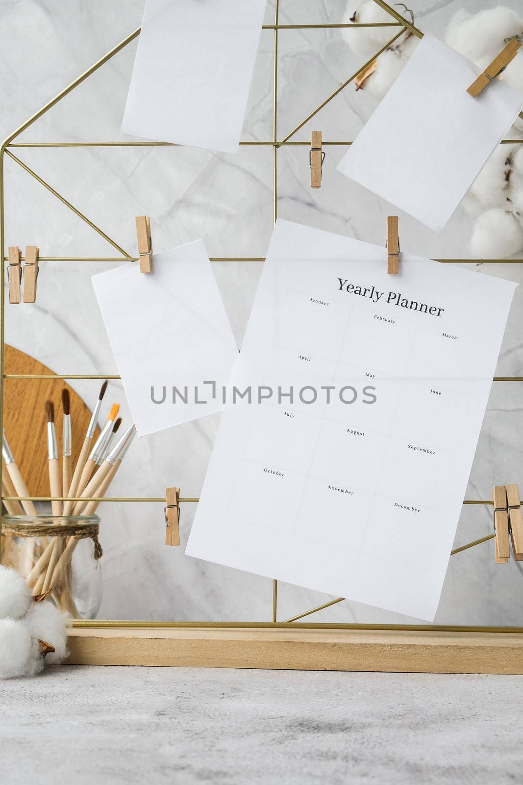 YEARLY PLANNER Cards and posters mock ups on grid board. Copy space. Home office desktop. Freelance bloggers workplace. Brushes and palette tools Creative