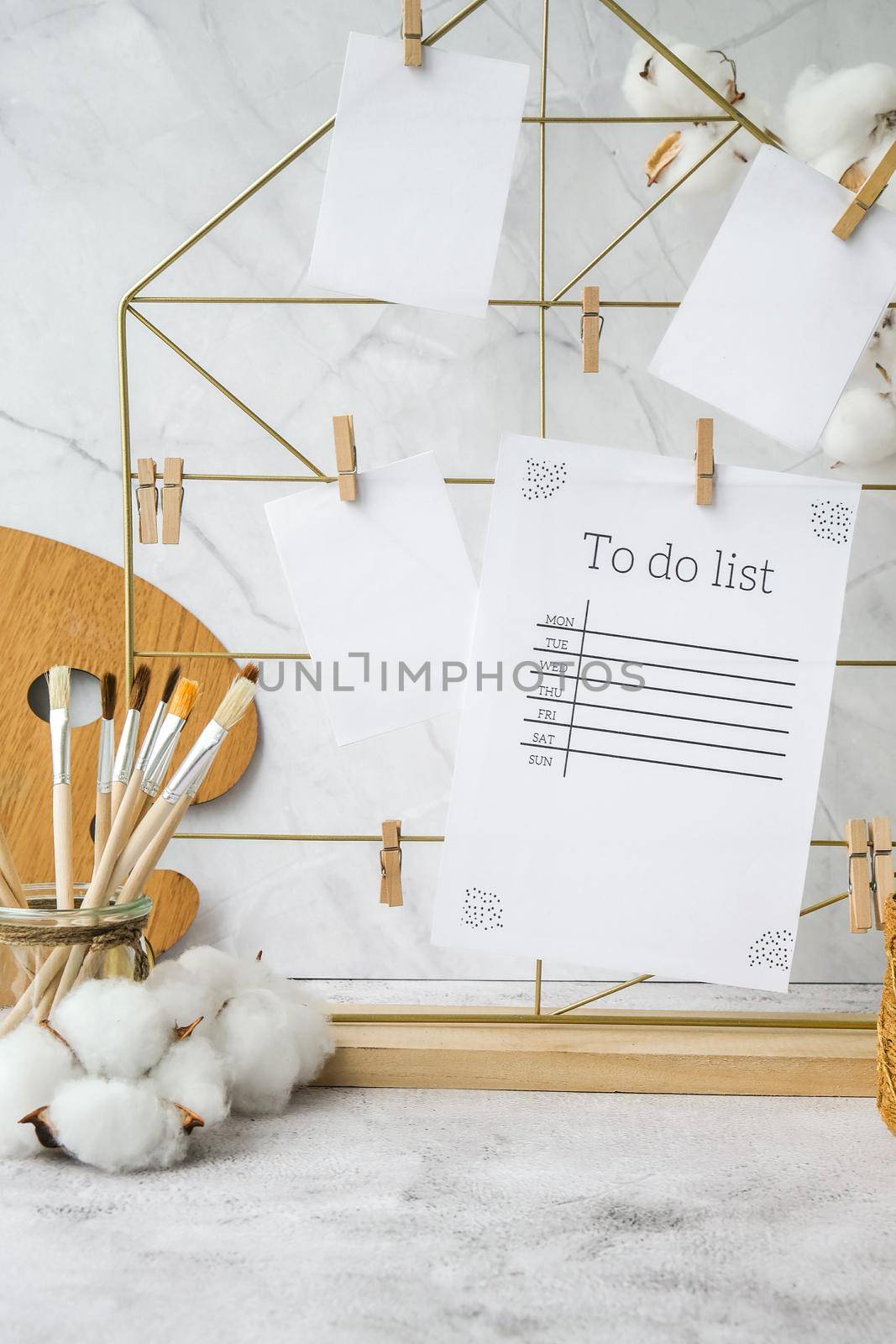 TO DO list cards and posters mock ups on grid board. Copy space. Home office desktop. Freelance bloggers workplace. Brushes and palette by anna_stasiia