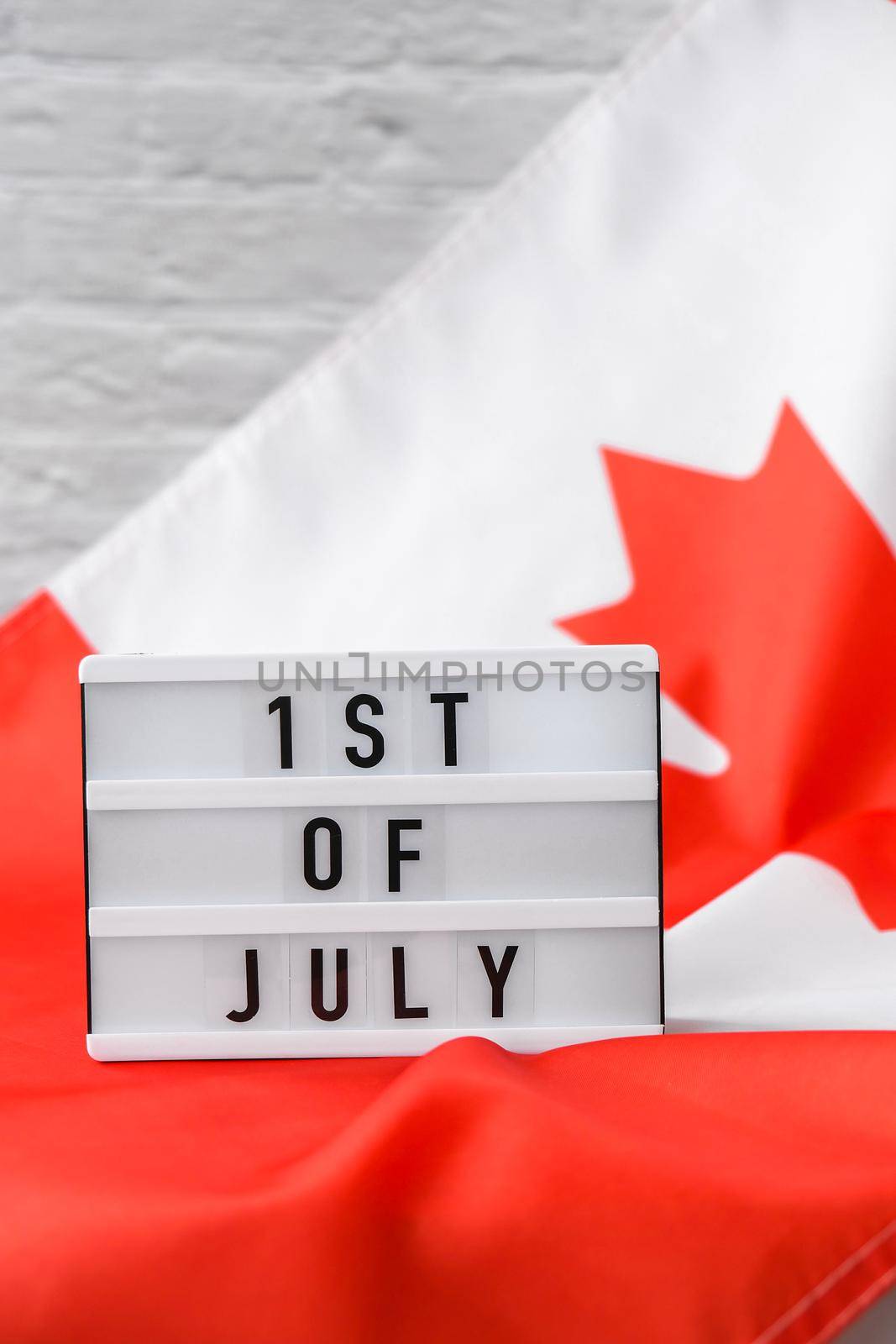 The National Flag of Canada. Lightbox with text 1ST OF JULY Canadian Flag or the Maple Leaf. Patriotism. International relations concept. Independence day. Immigration