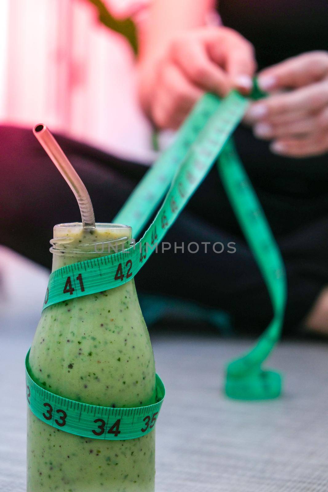 Young millenial blond woman drinking vegan smoothie drink detox. Woman doing yoga exercises at home. Clean eating, weight loss, healthy dieting food concept. Stay healthy. Wellness