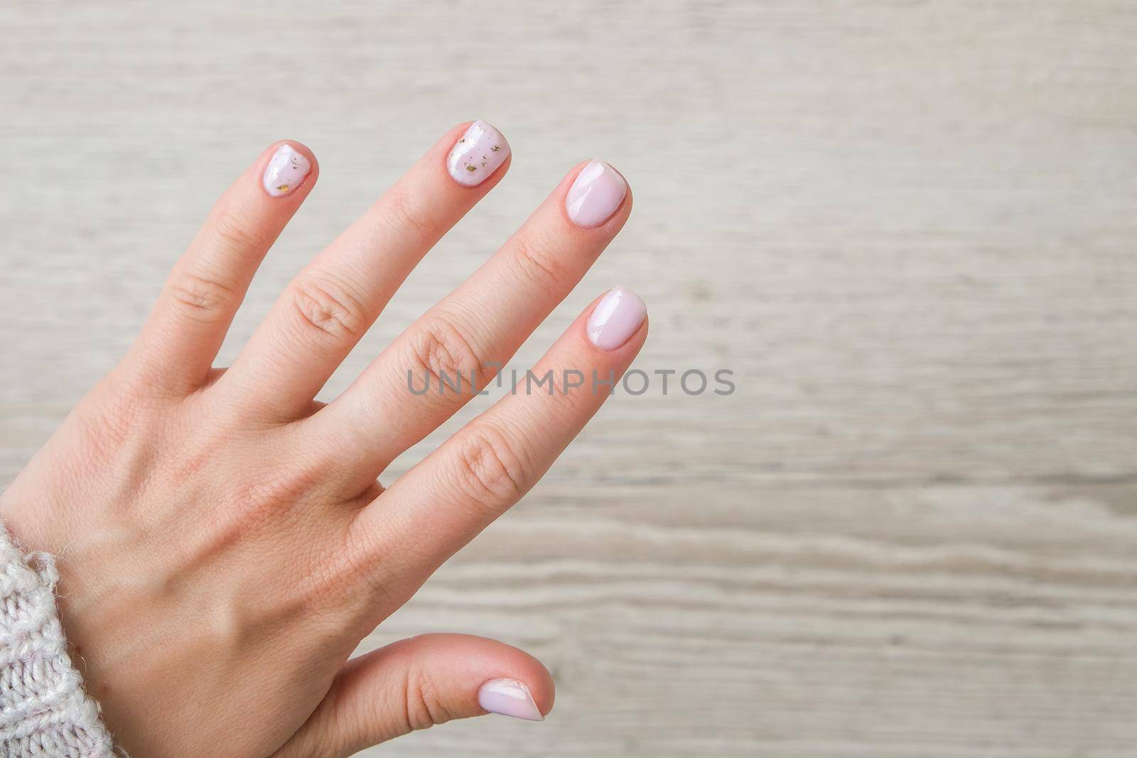 Closeup elegant pastel natural modern design manicure. Female hands. Gel nails. Nude manicure. Beige color. Clean skin. Spa salon, advertisement. Skin care. Beauty. Nail care. Beauty treatment. Copy space