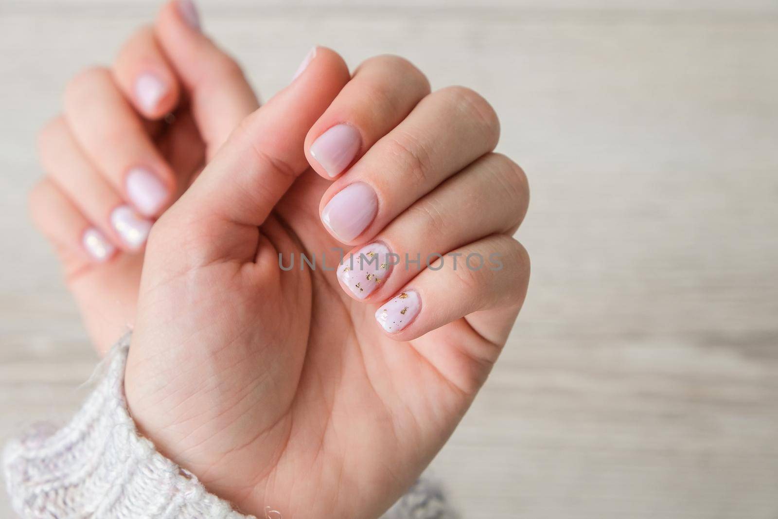 Closeup elegant pastel natural modern design manicure. Female hands. Gel nails. Nude manicure. Beige color. Clean skin. Spa salon, advertisement. Skin care. Beauty. Nail care. Beauty treatment. Copy space