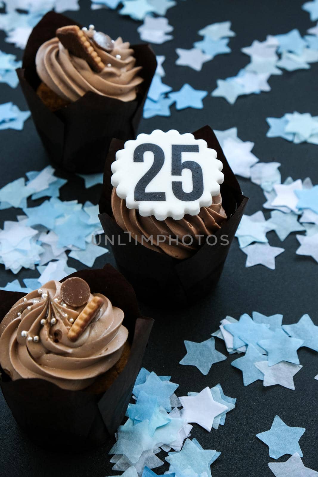 Number 25 on Delicious chocolate cupcake with cream on dark background. Muffin. Birthday cake party. Homemade Chocolate Cupcake. 25 years old anniversary