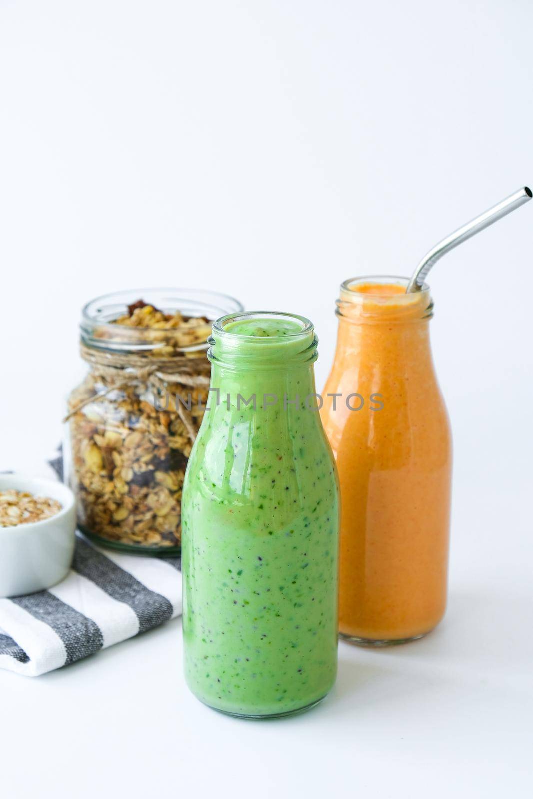 Seasonal Matcha green vegan smoothie with chia seeds and mint pumpkin carrot smoothie drink detox Glass jar granola muesli oatmeal breakfast. Clean eating, weight loss, healthy dieting food concept Fruit vegetable drink fitness