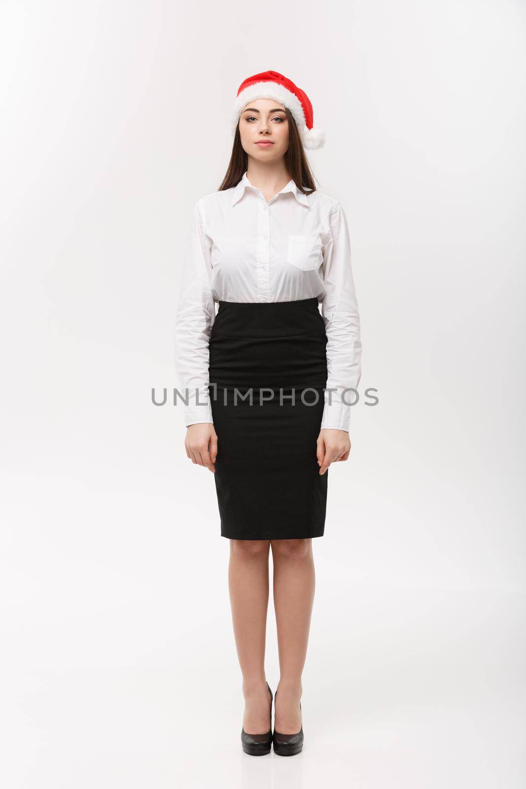 Business Concept - Modern caucasian business woman in christmas theme posing on white studio background with copy space.