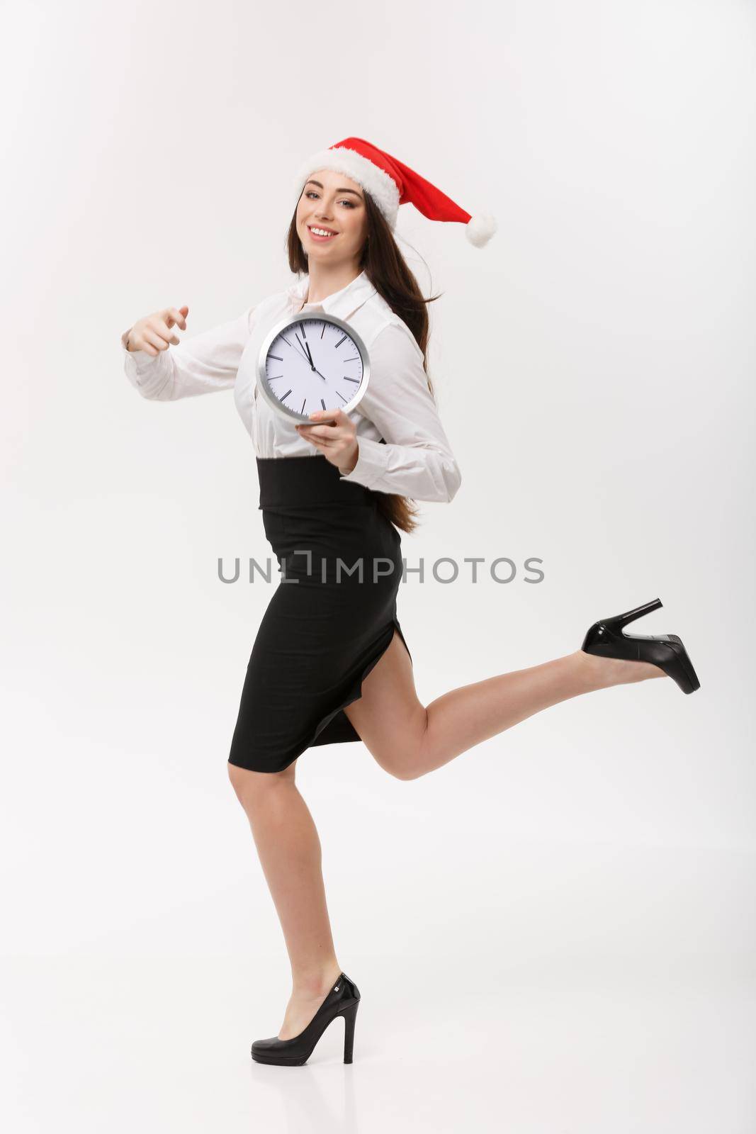 Rush time Concept - beautiful young caucasian woman running with clock isolated on white. by Benzoix