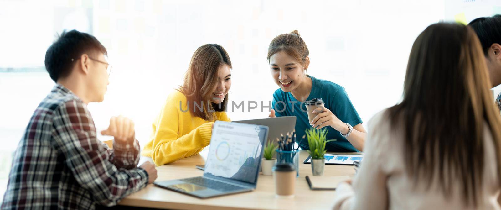 Business meeting time. Colleagues present their ideas and analyze plans during meeting in loft office of modern business center. Business team discusses marketing strategy. Brainstorming concept.