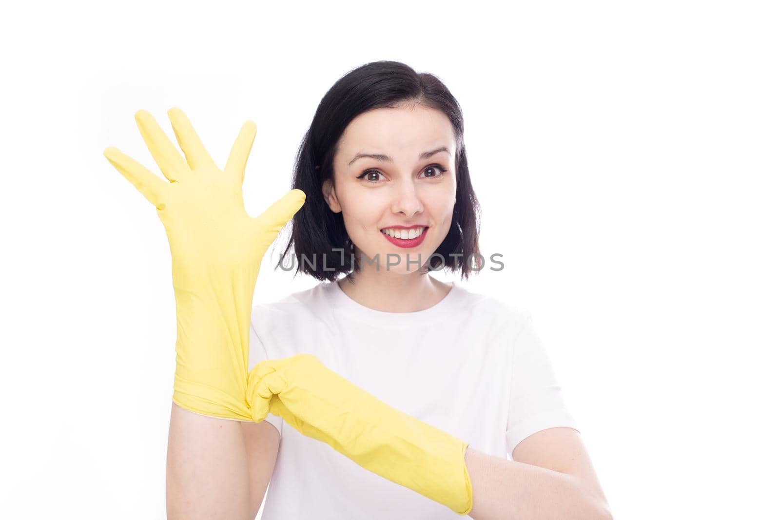 happy woman in a white t-shirt puts cleaning gloves on her hands. High quality photo