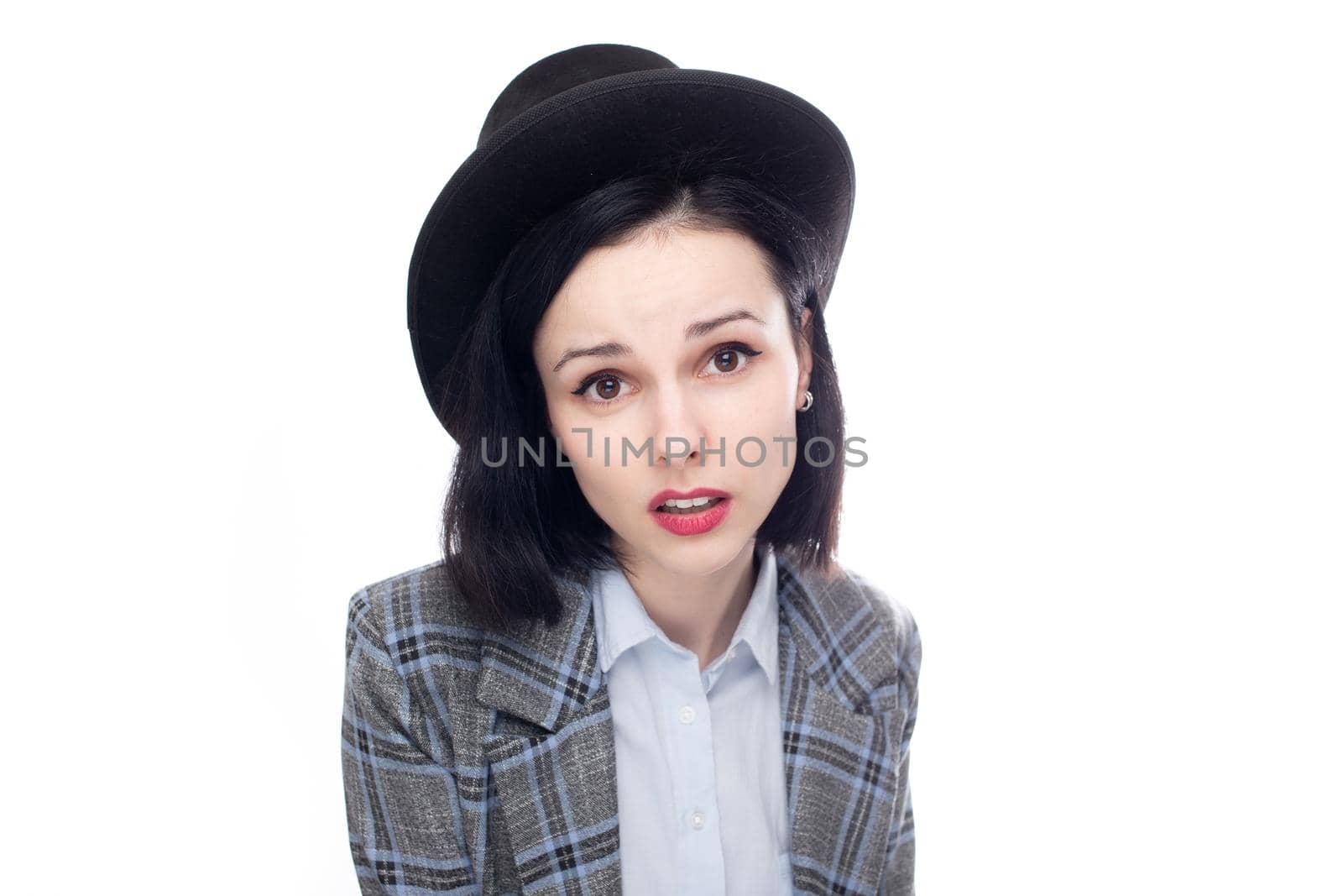 cute woman in office suit and top hat, white studio background. High quality photo