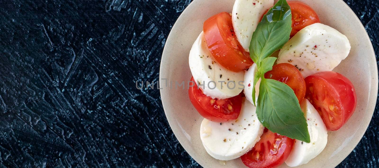 banner with close-up of tomato and mozzarella circles with basil leaf. serving of Italian caprese salad. flat lay. Soft focus. top view