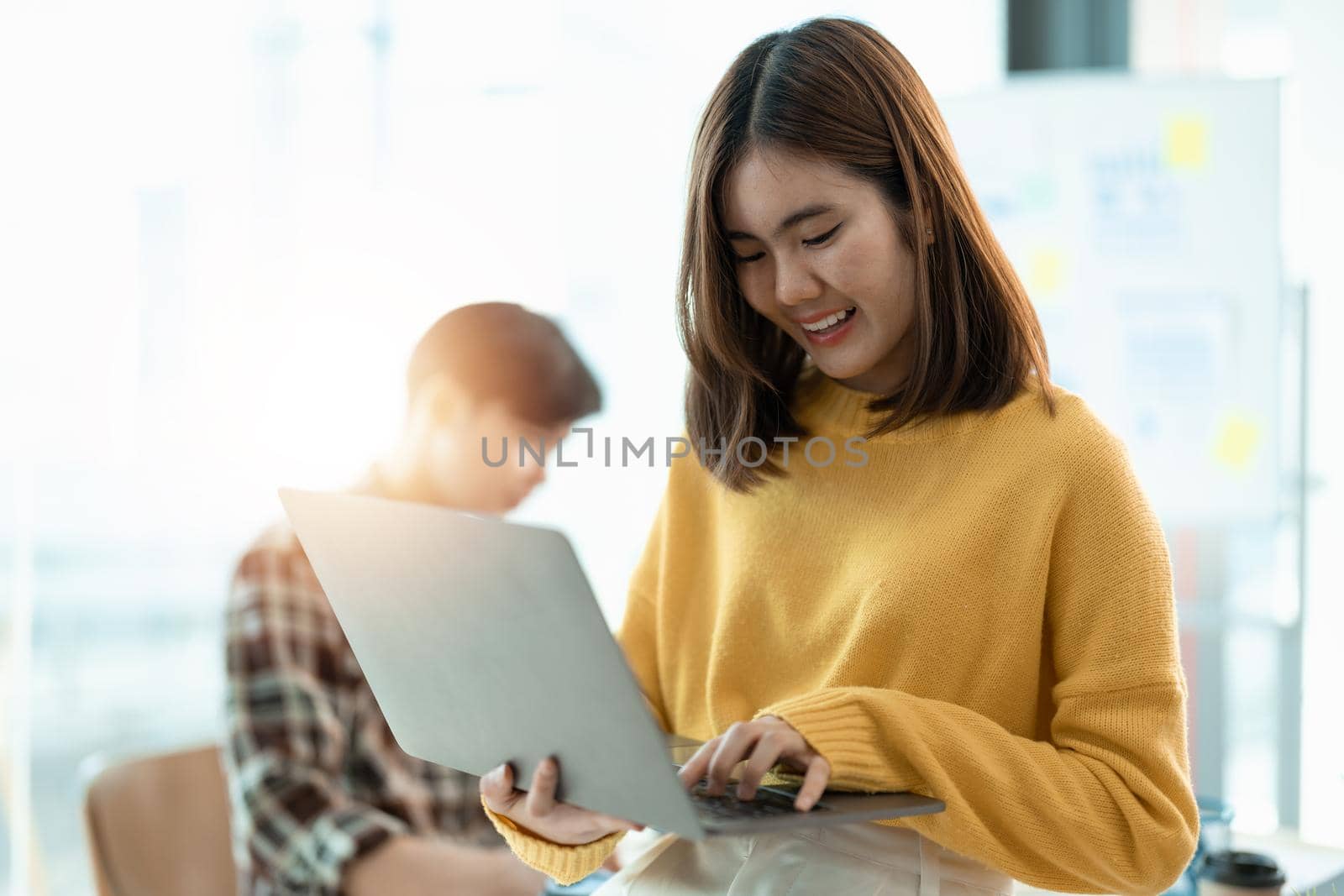 Young asian woman using laptop computer at meeting room.