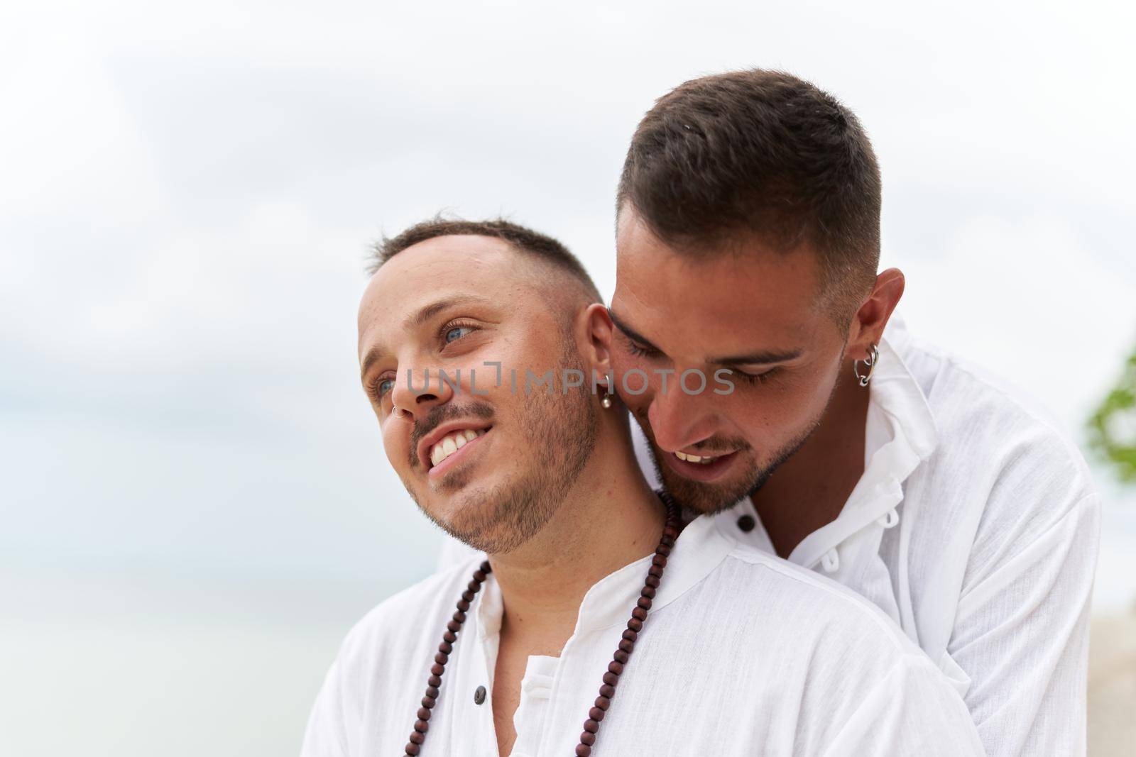 Close up photo of a gay couple in love embracing on a beach by WesternExoticStockers